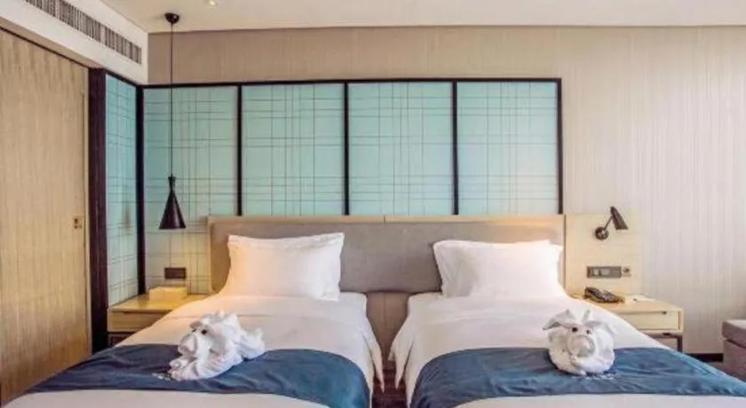 Bed in Echarm Hotel Qionghai Wanquan River