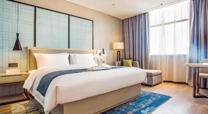 Bed in Echarm Hotel Qionghai Wanquan River