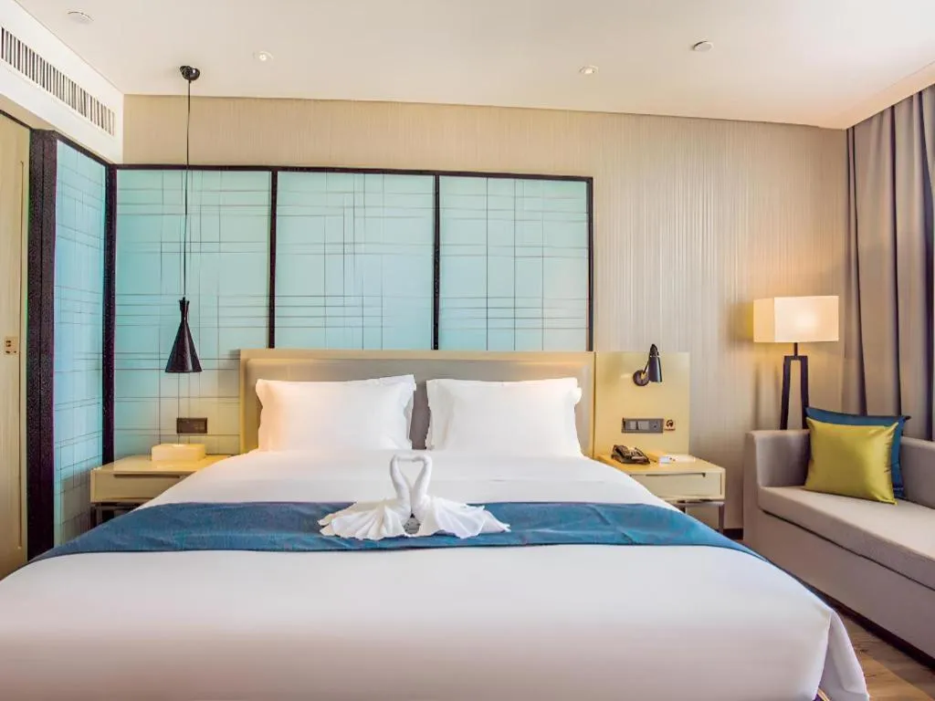 Bed in Echarm Hotel Qionghai Wanquan River