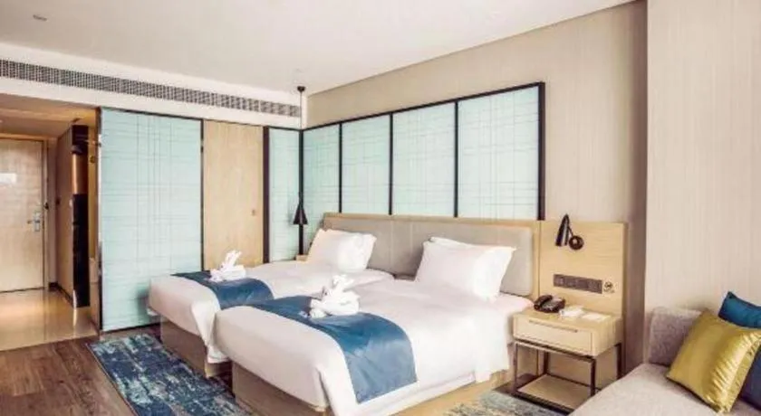 Bed in Echarm Hotel Qionghai Wanquan River