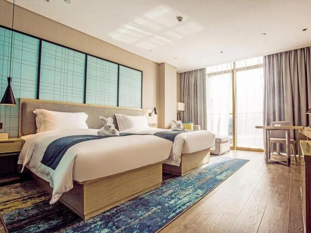 Bed in Echarm Hotel Qionghai Wanquan River