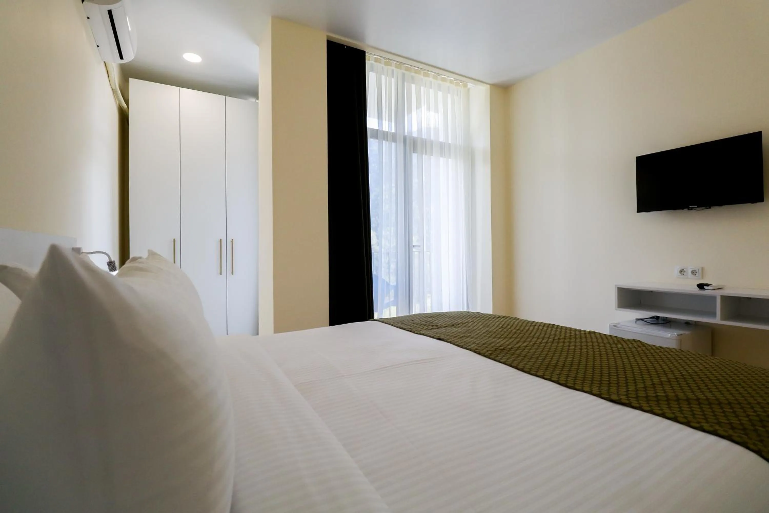 Communal lounge/ TV room, Bed in Emerald Borjomi Hotel