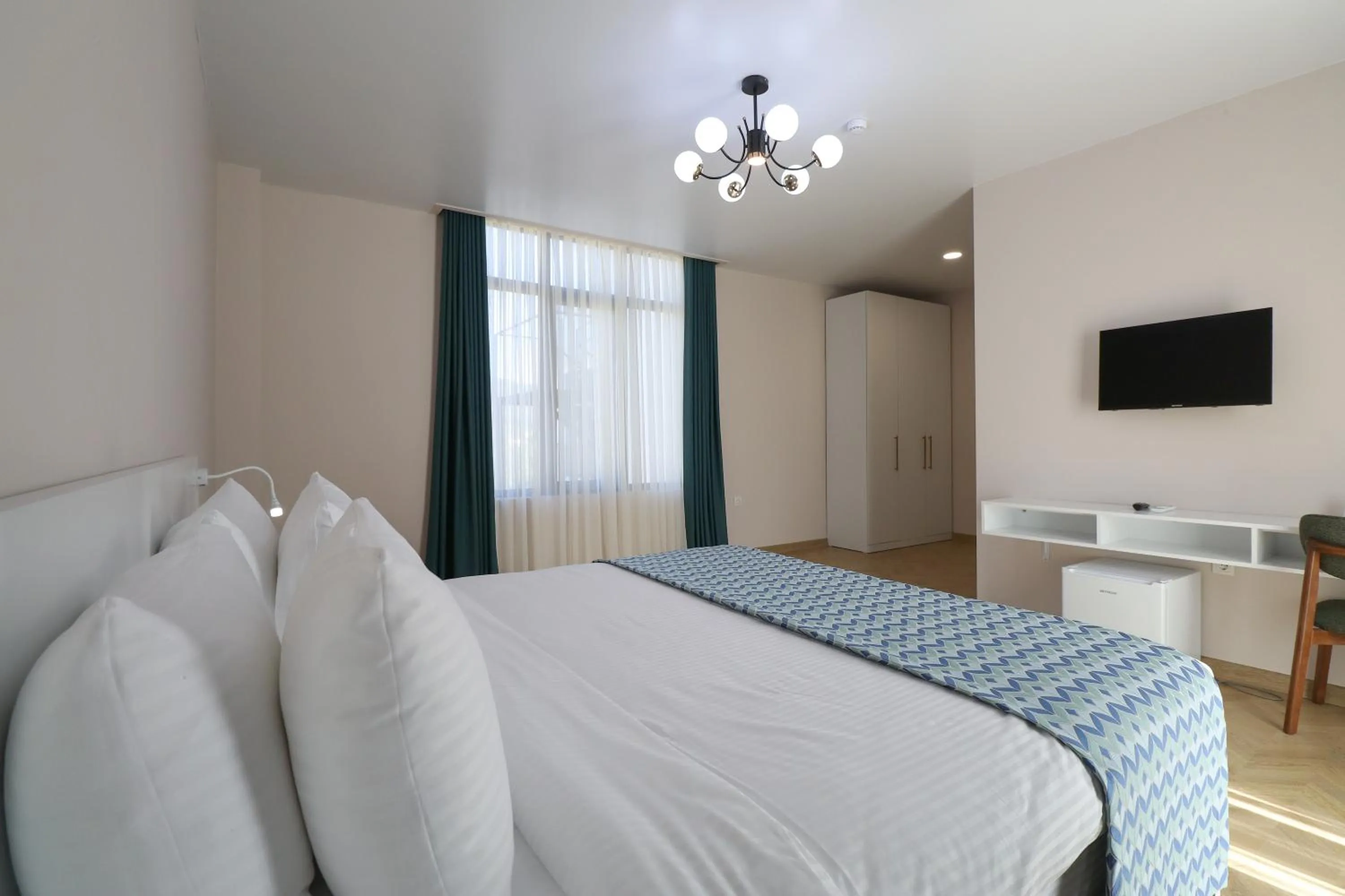 Communal lounge/ TV room, Bed in Emerald Borjomi Hotel