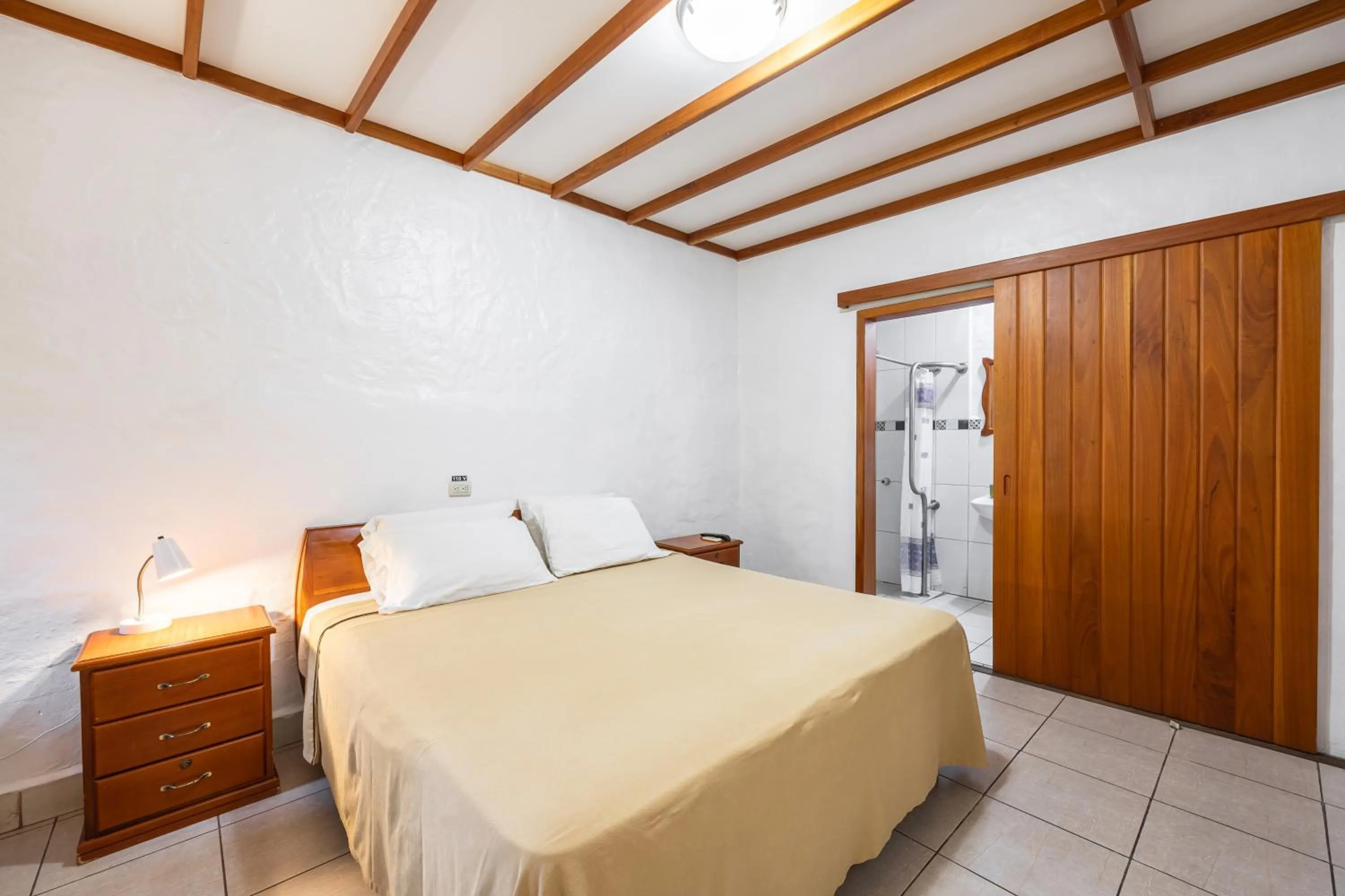 Bed in La Peregrina Galapagos B&B