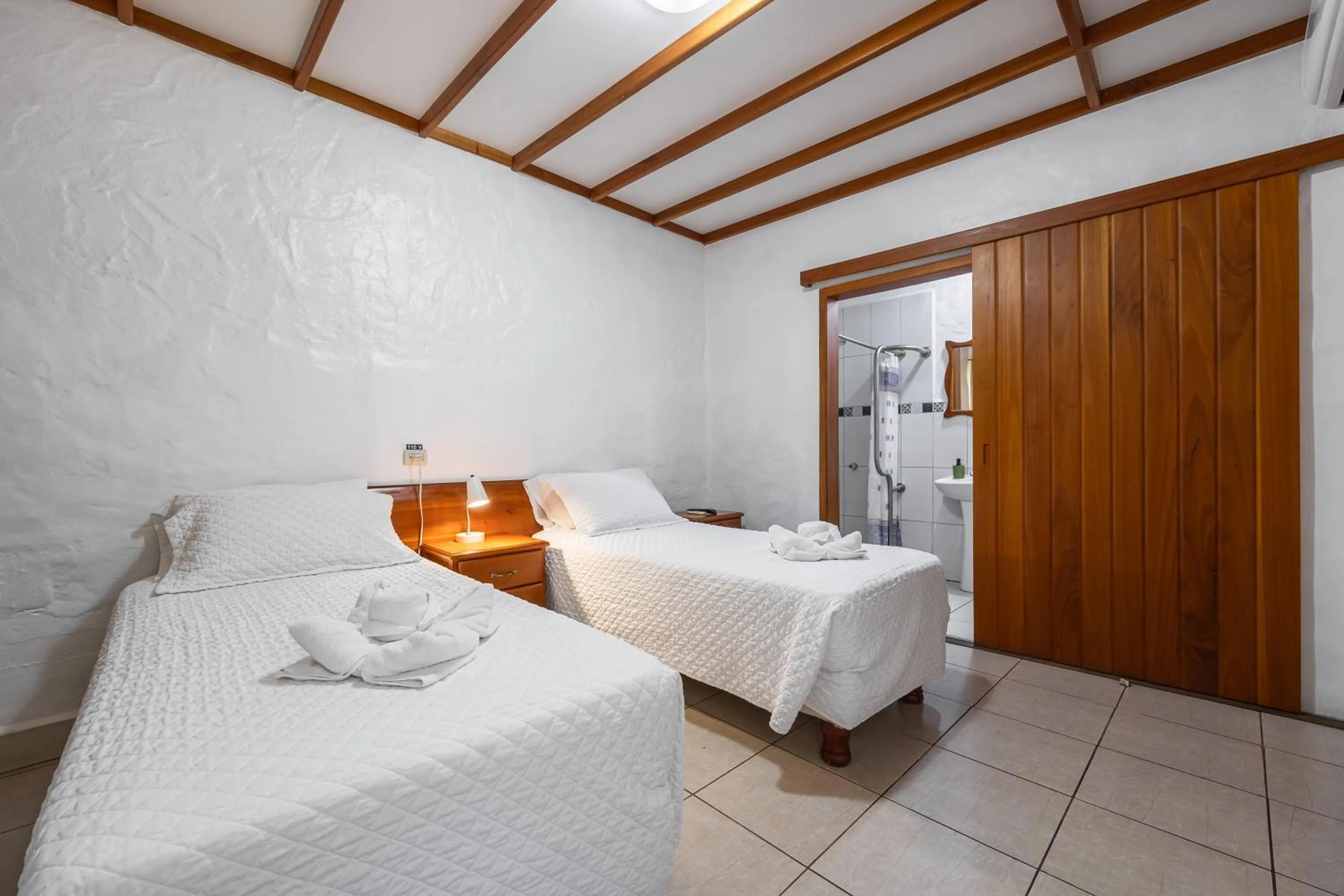 Bed in La Peregrina Galapagos B&B