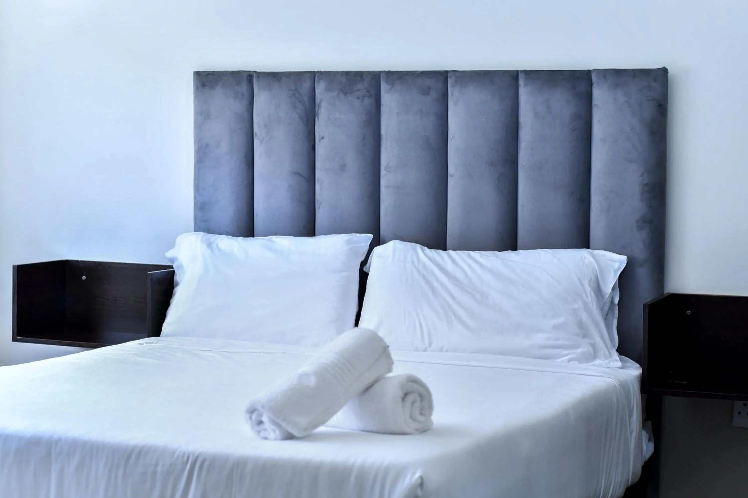 Bed in Bayside Hotel Suites