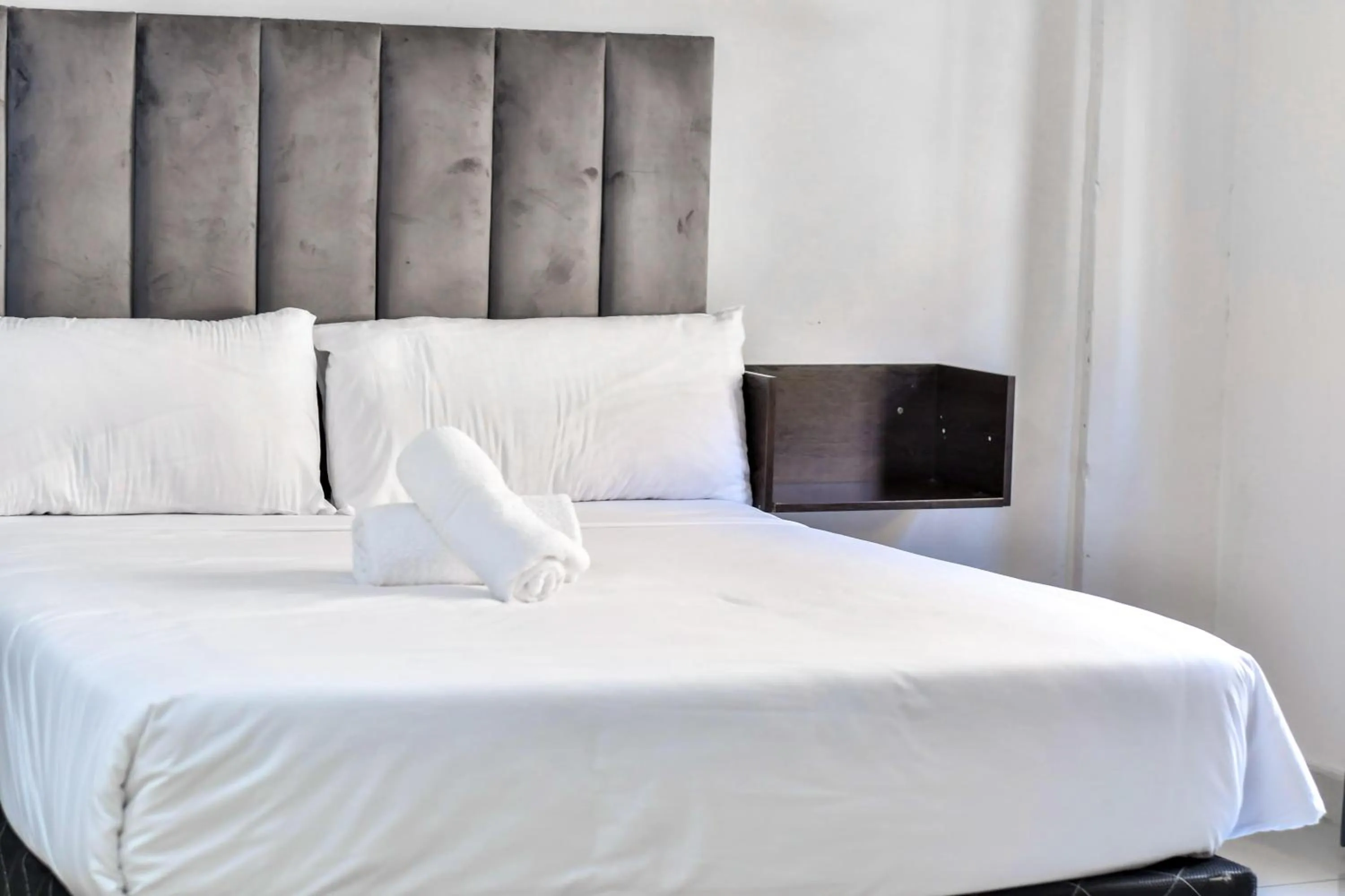 Bed in Bayside Hotel Suites