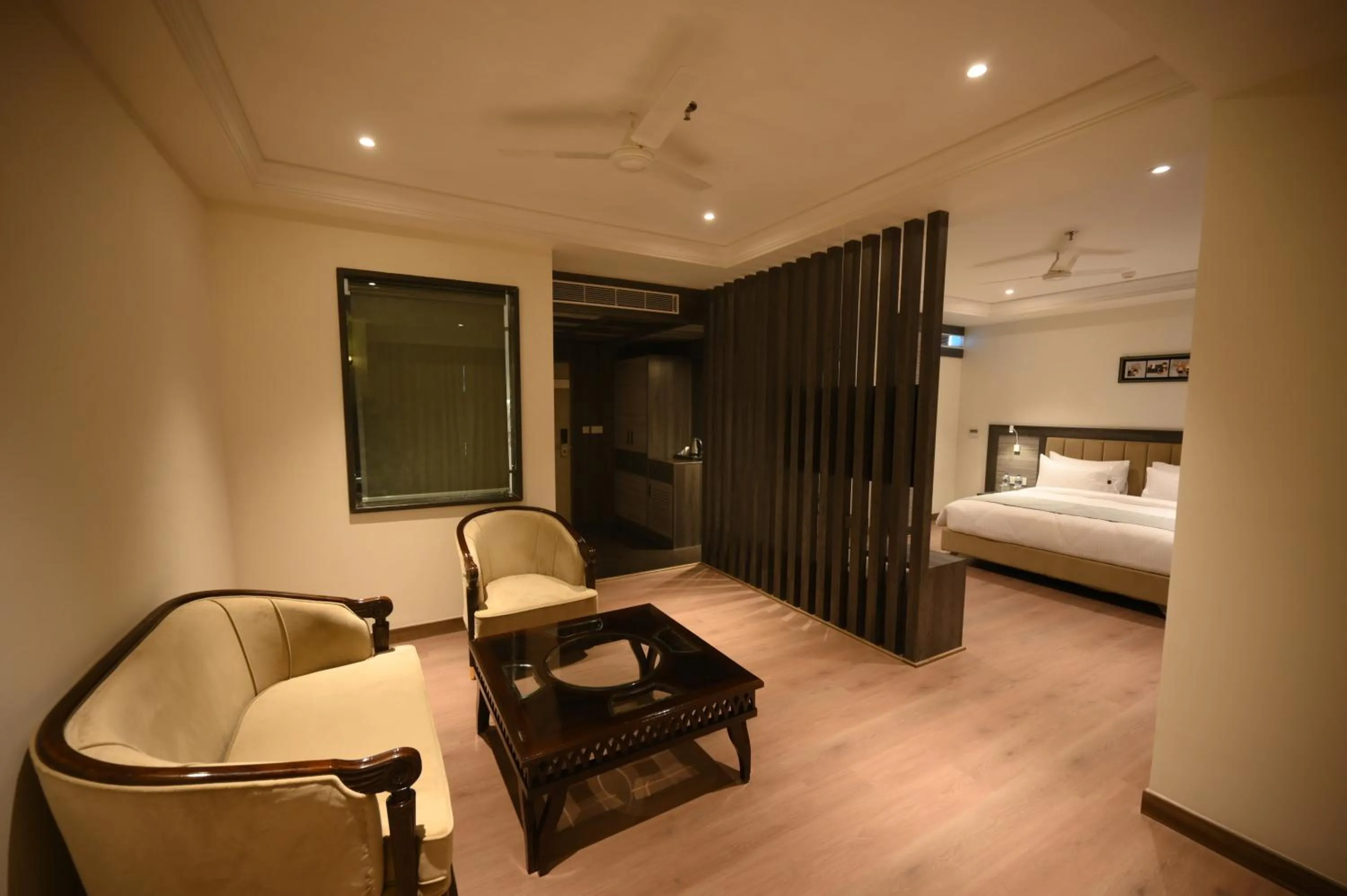 Seating area, Bed in The Mudra Hotel