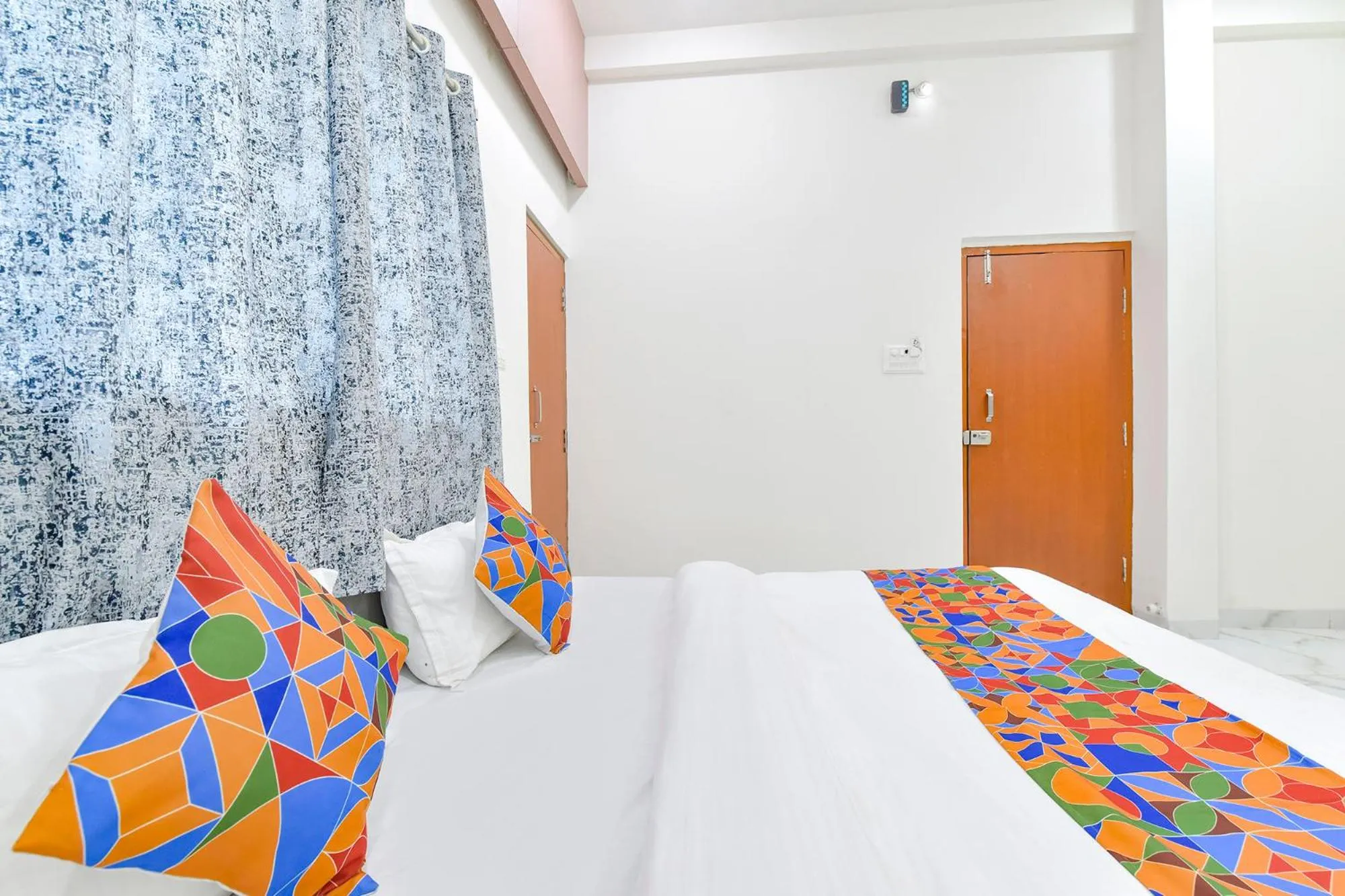 Bed in FabHotel Grand Embassy