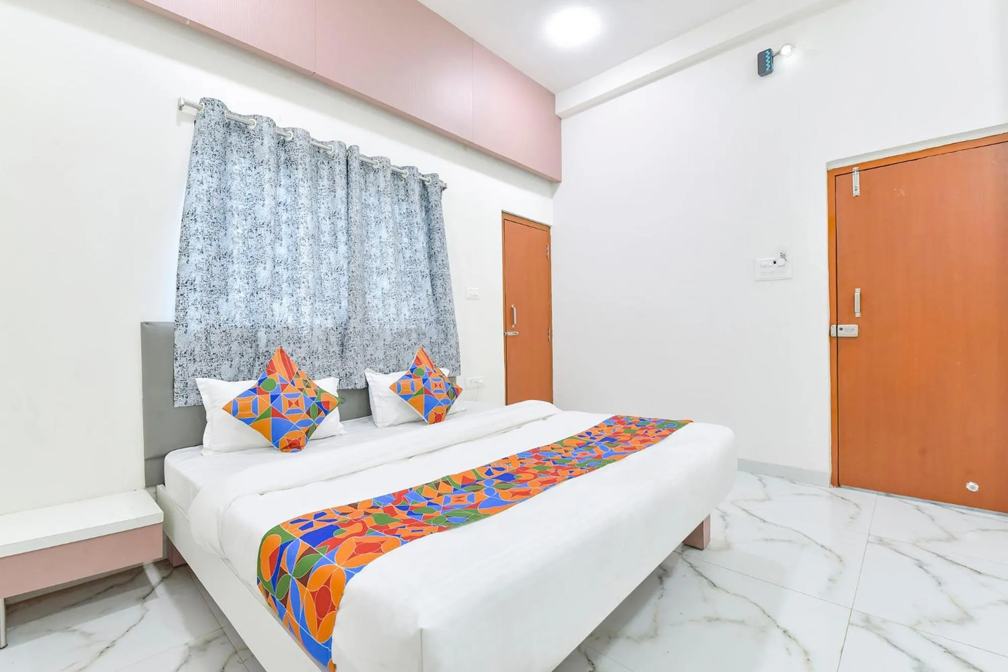 Bed in FabHotel Grand Embassy