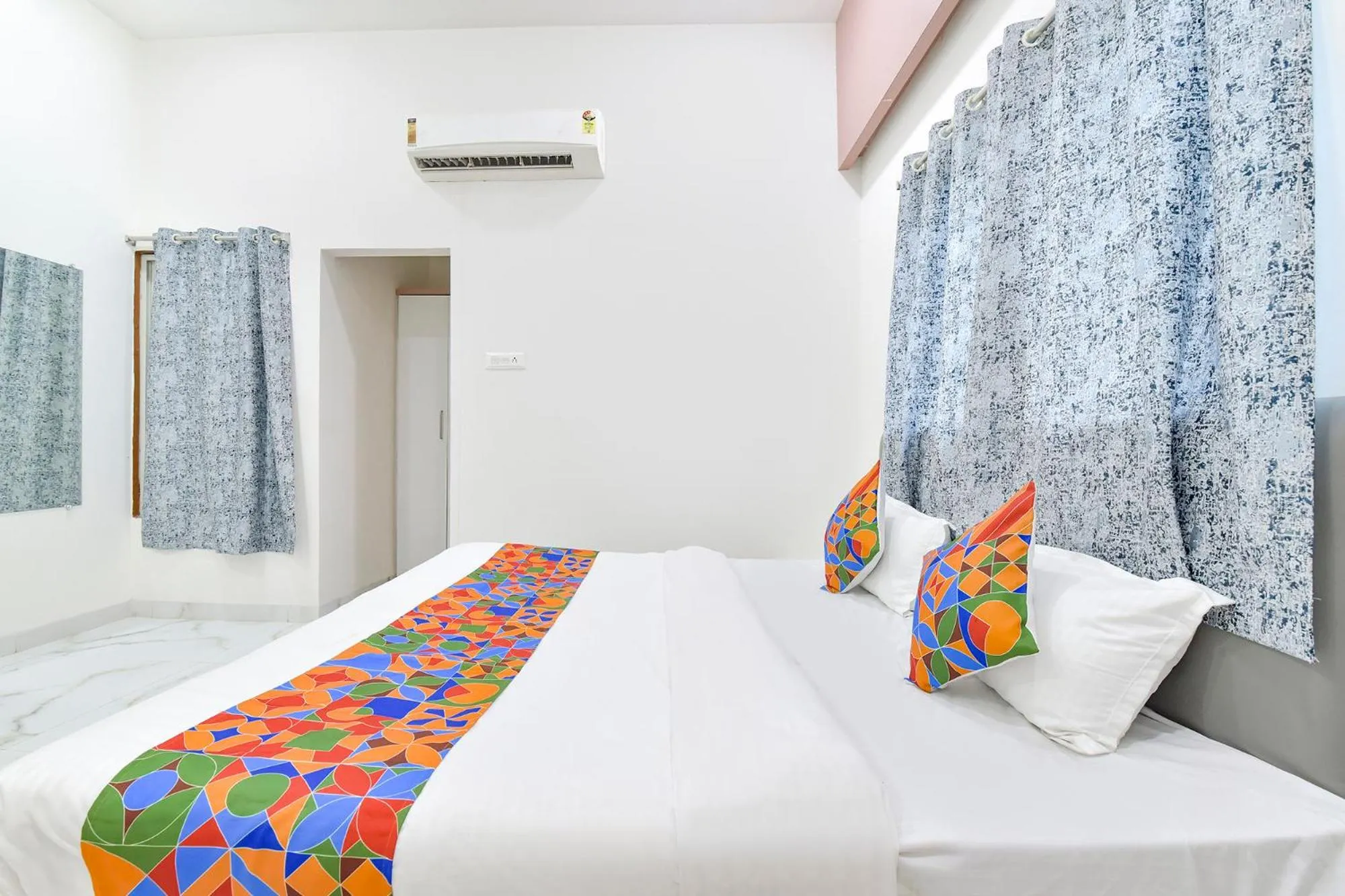 Bed in FabHotel Grand Embassy