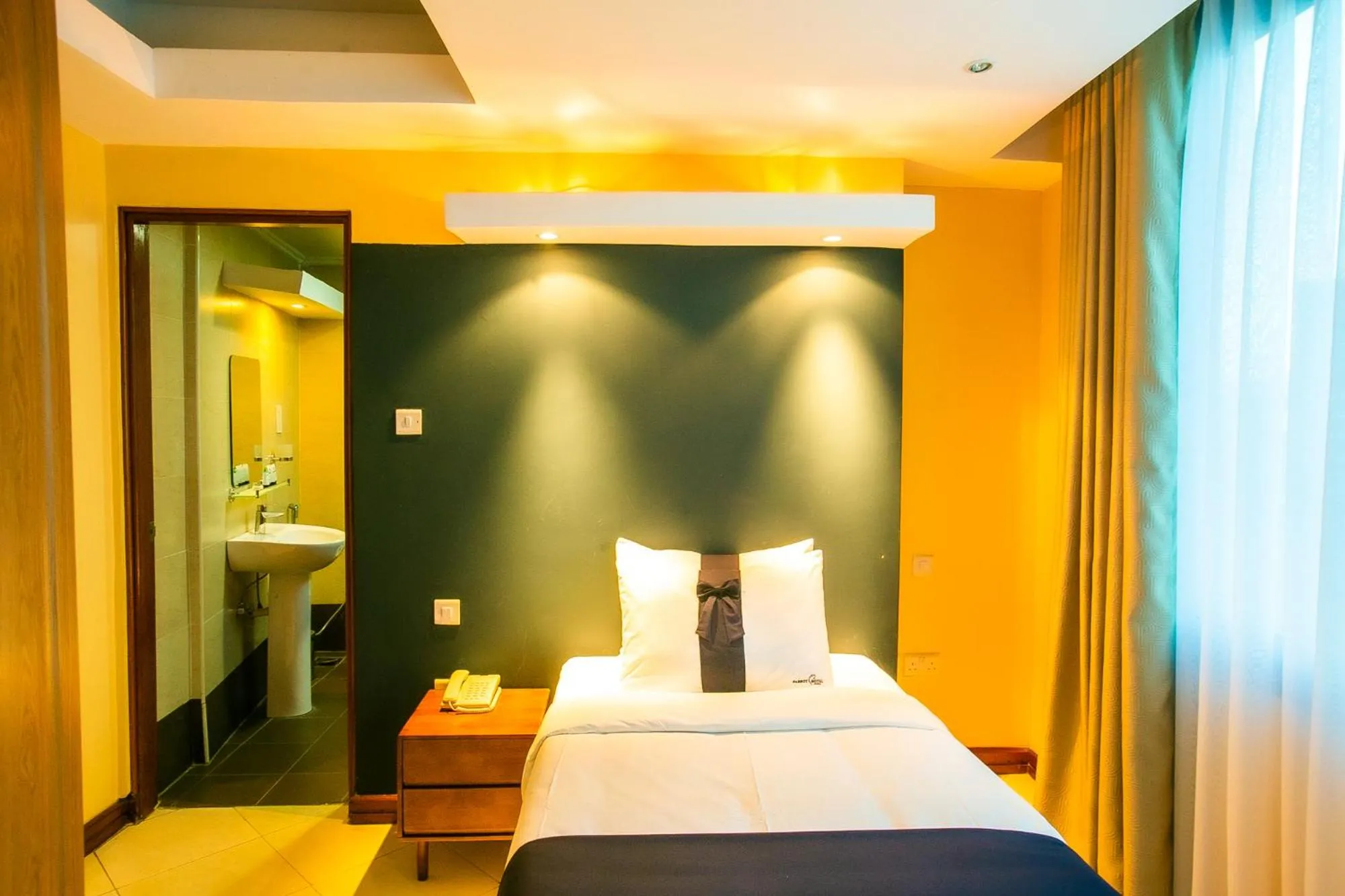 Bed in Parrot Hotel Arusha