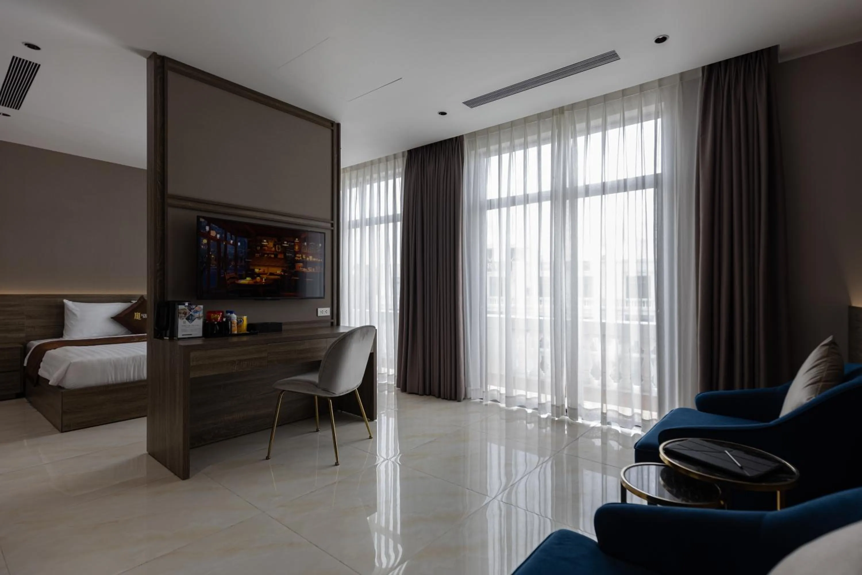 Living room, Bed in Luxhome Mekong Hotel