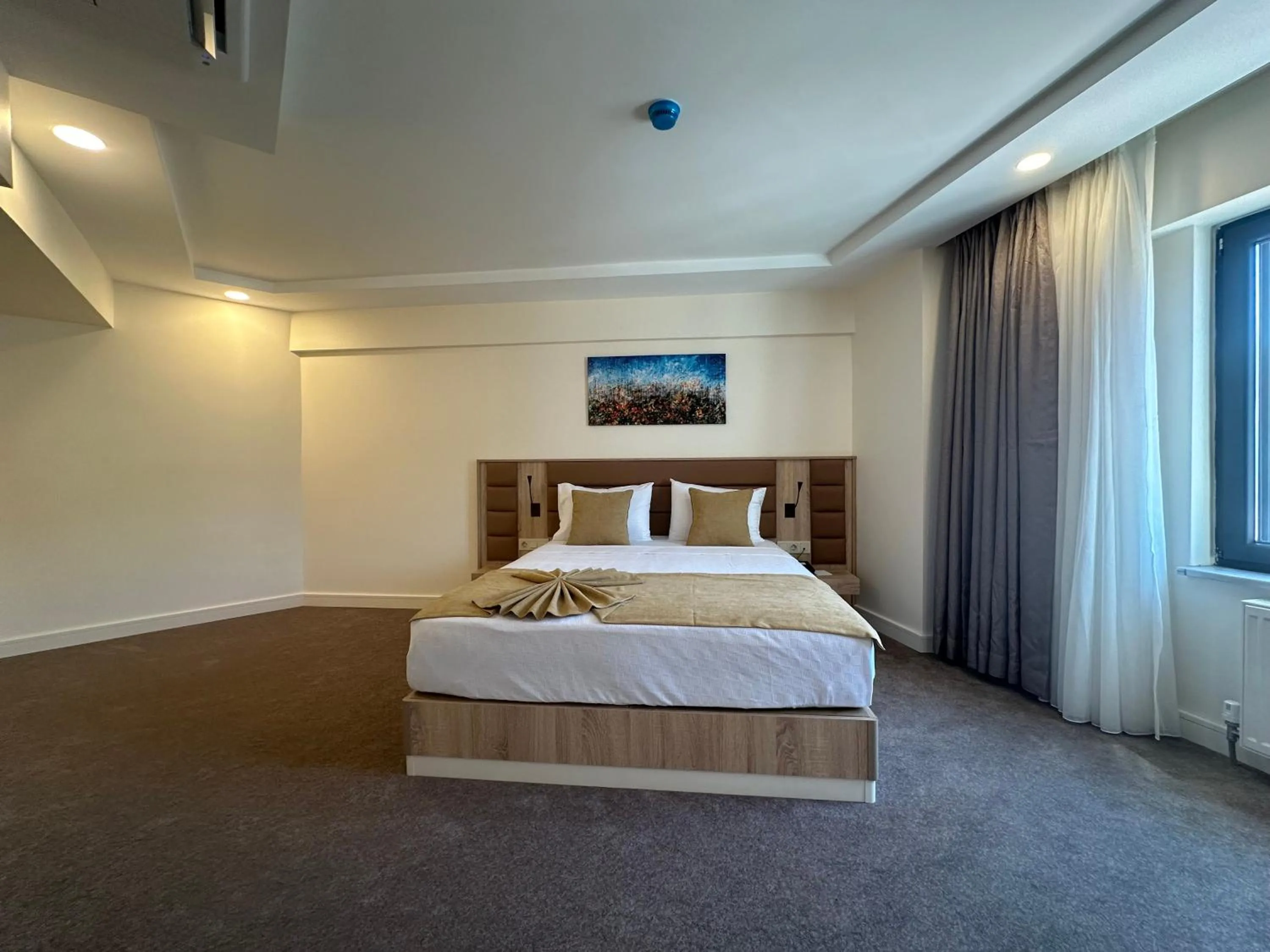 Bed in Roys Hotel & Suites