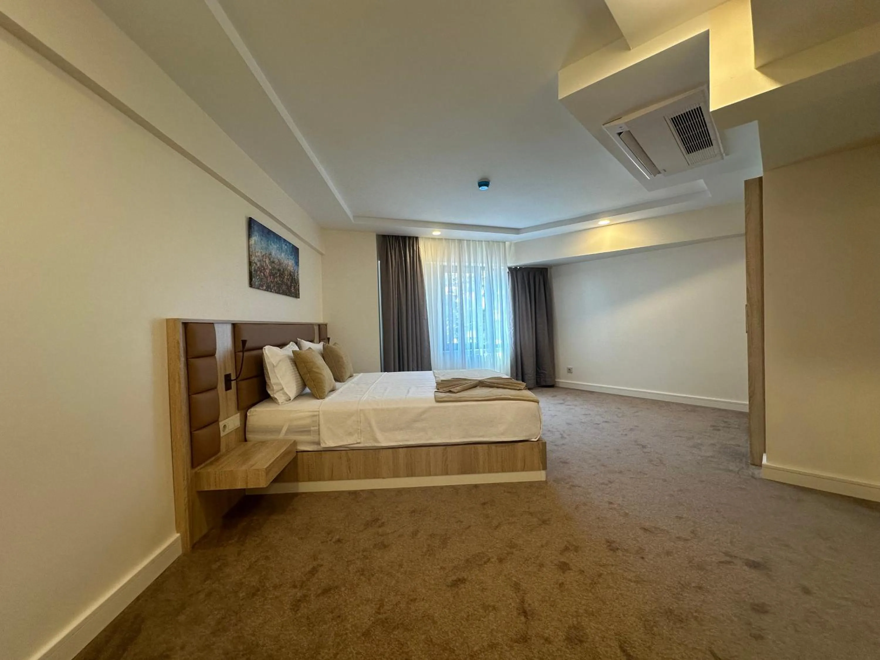 Bed in Roys Hotel & Suites