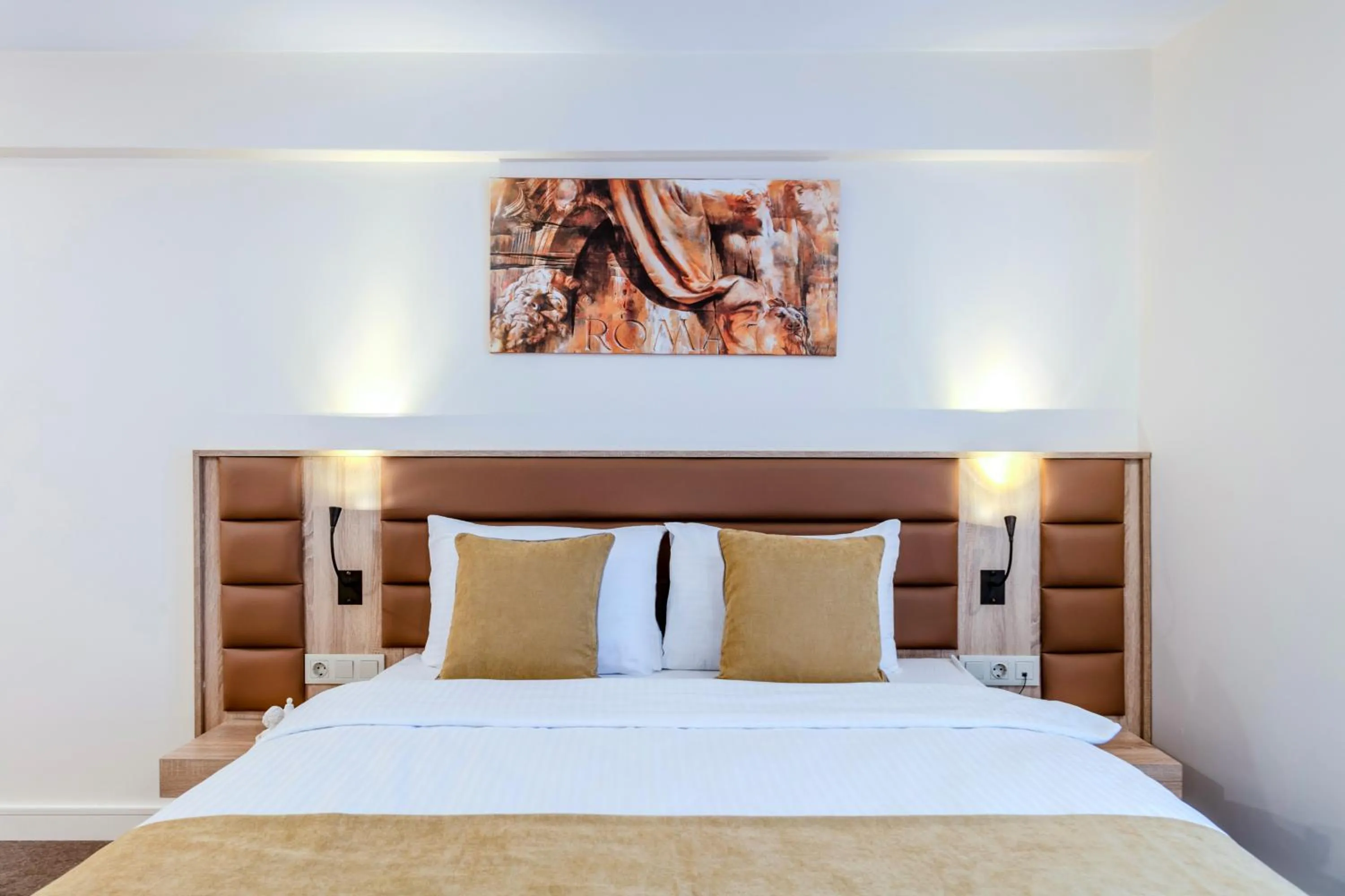 Bed in Roys Hotel & Suites