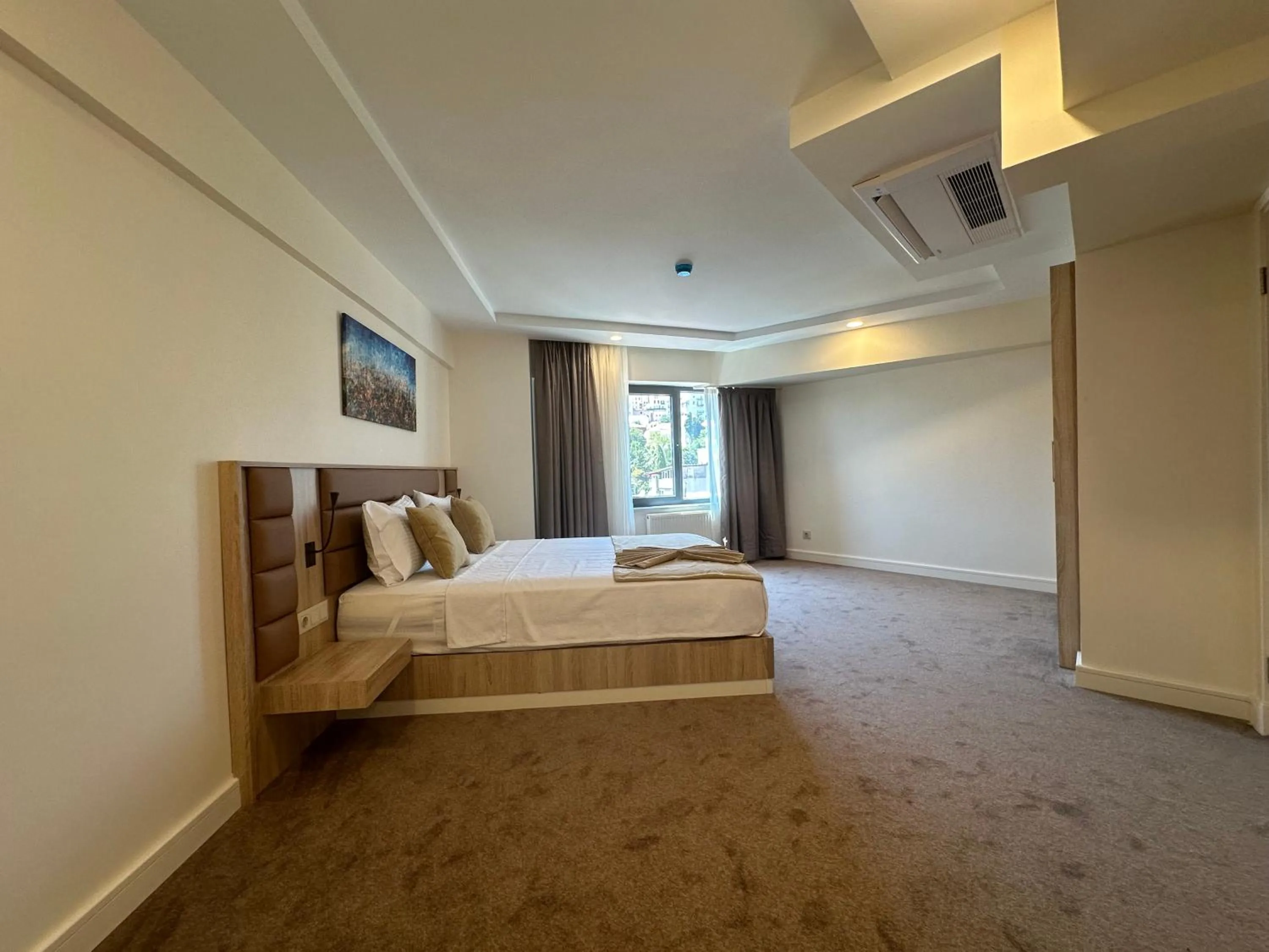 Bed in Roys Hotel & Suites