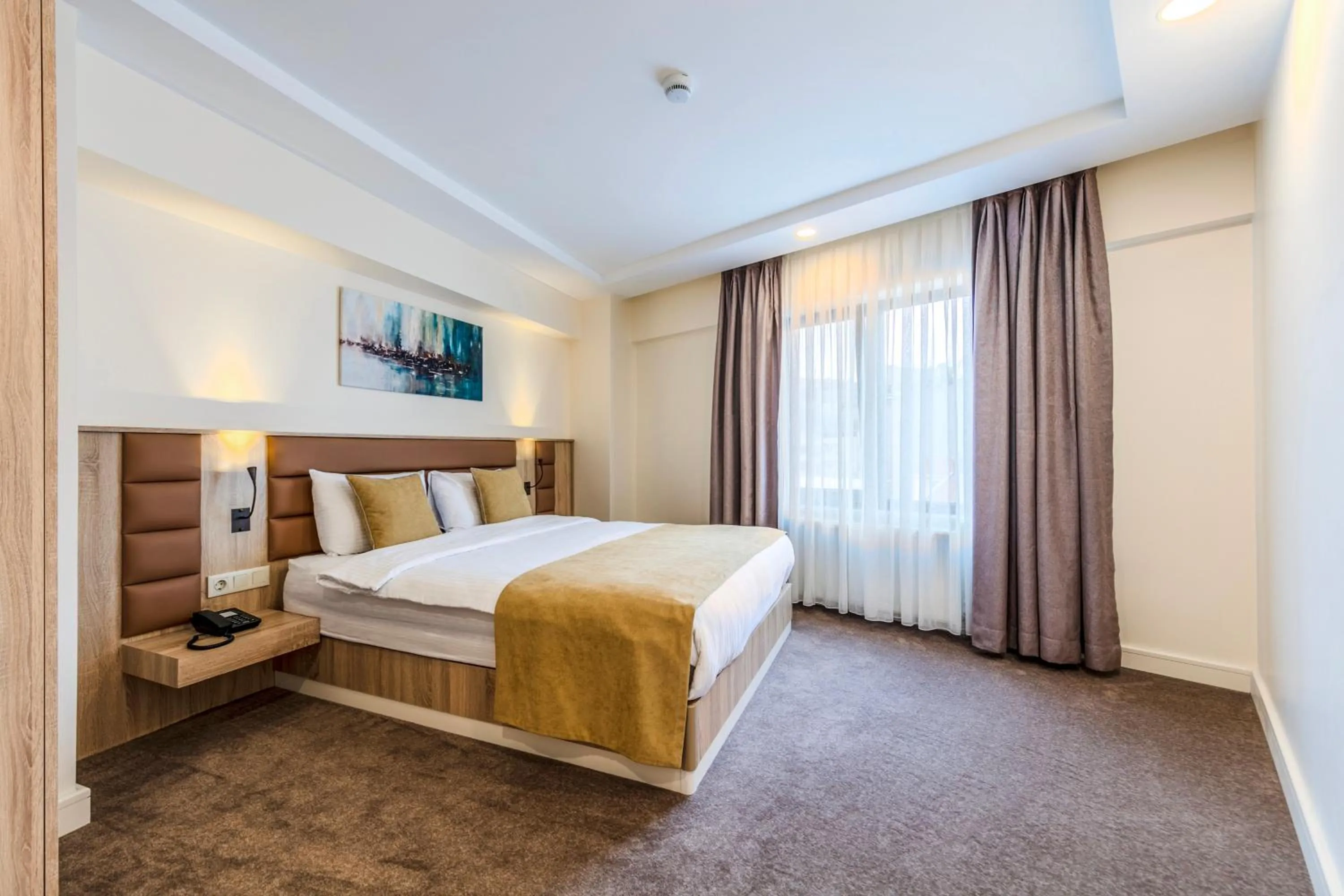 Bed in Roys Hotel & Suites