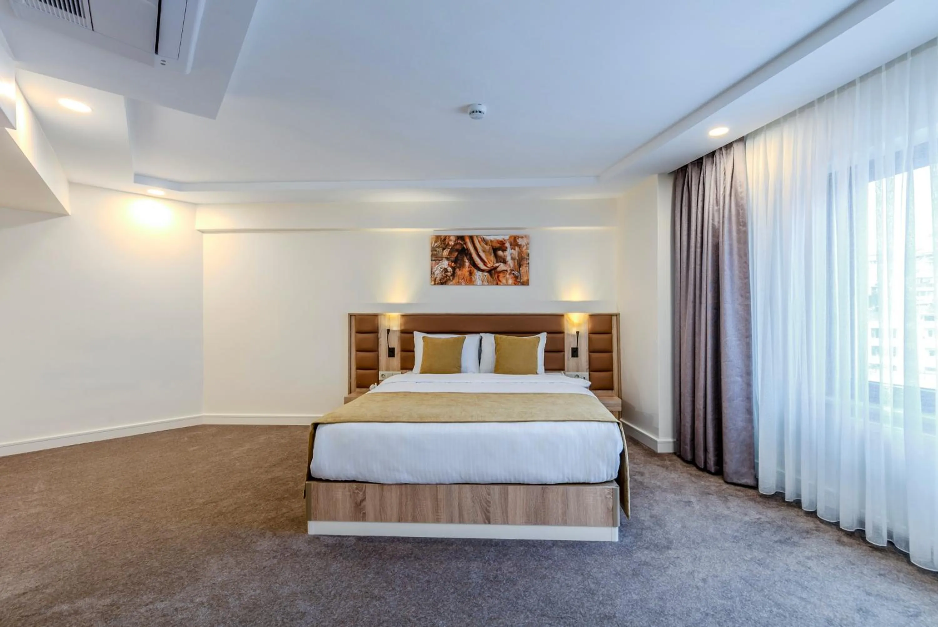 Bed in Roys Hotel & Suites