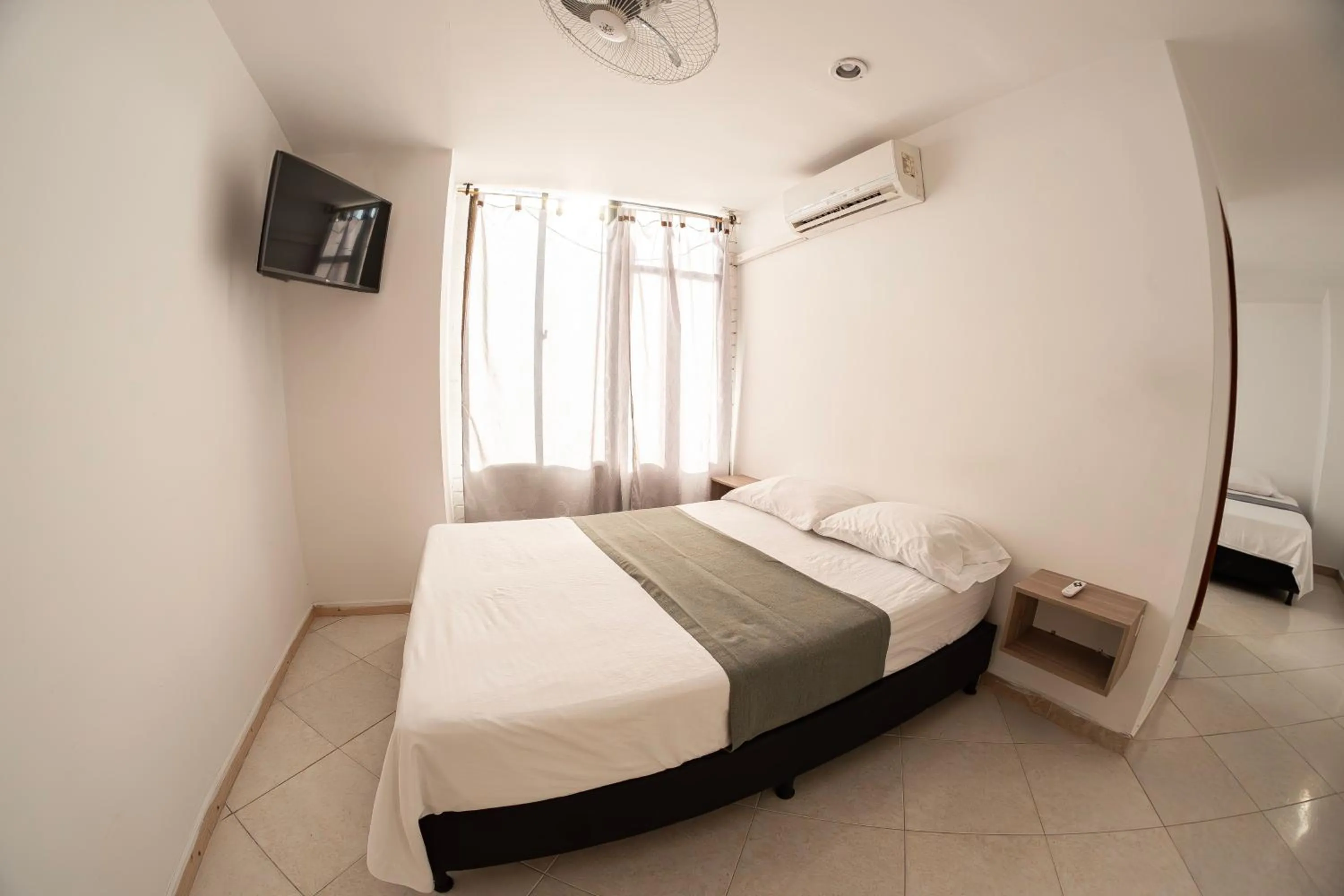 Communal lounge/ TV room, Bed in Hotel Santander Plaza