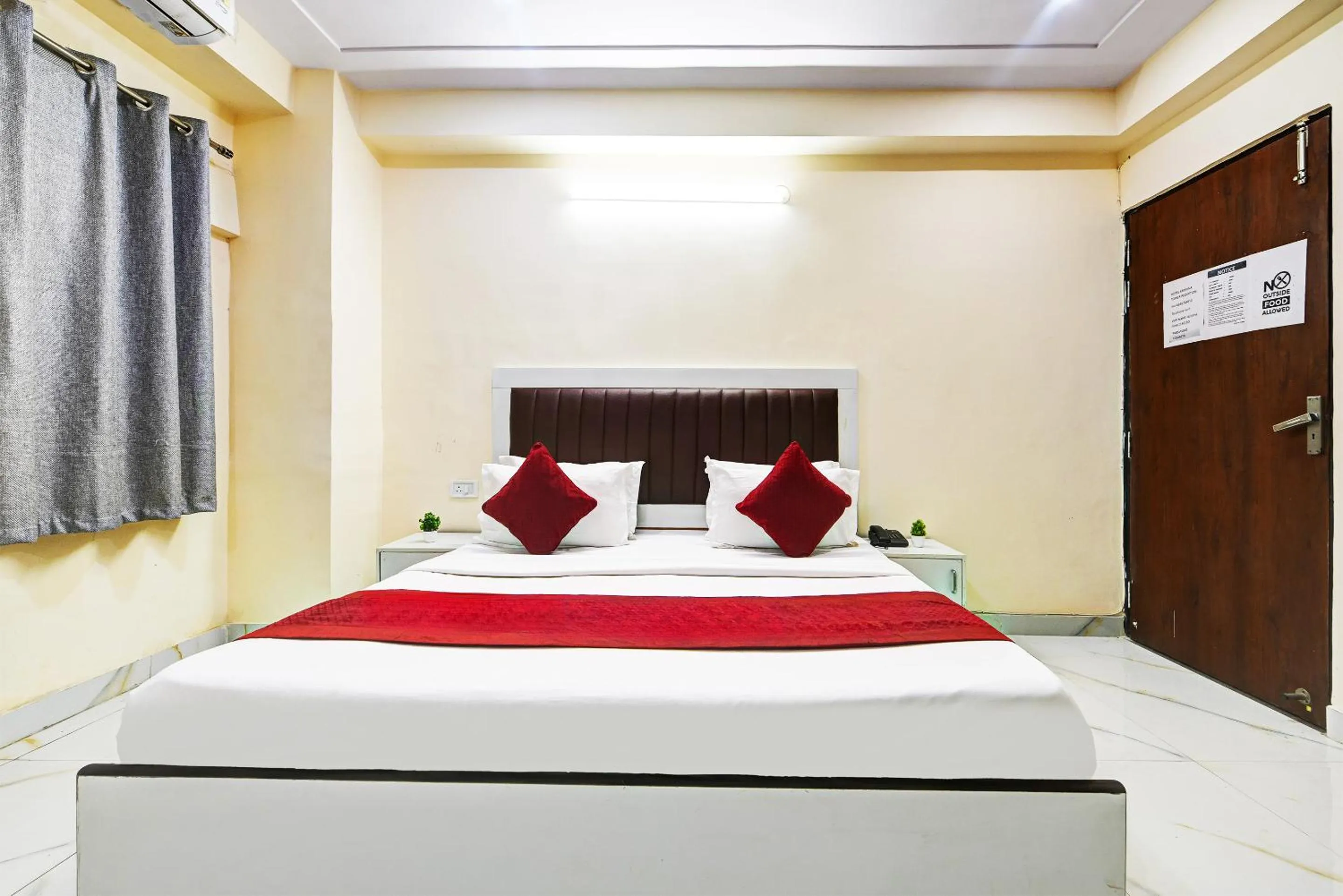 Bed in Hotel Krishna Tower
