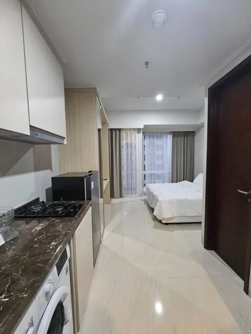 Bed in Green Sedayu Apartment Suite by Ellison