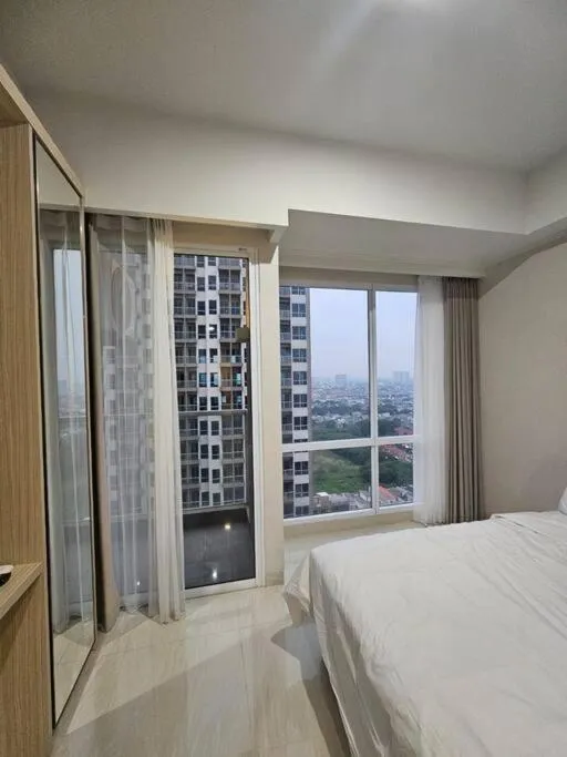 Bed in Green Sedayu Apartment Suite by Ellison