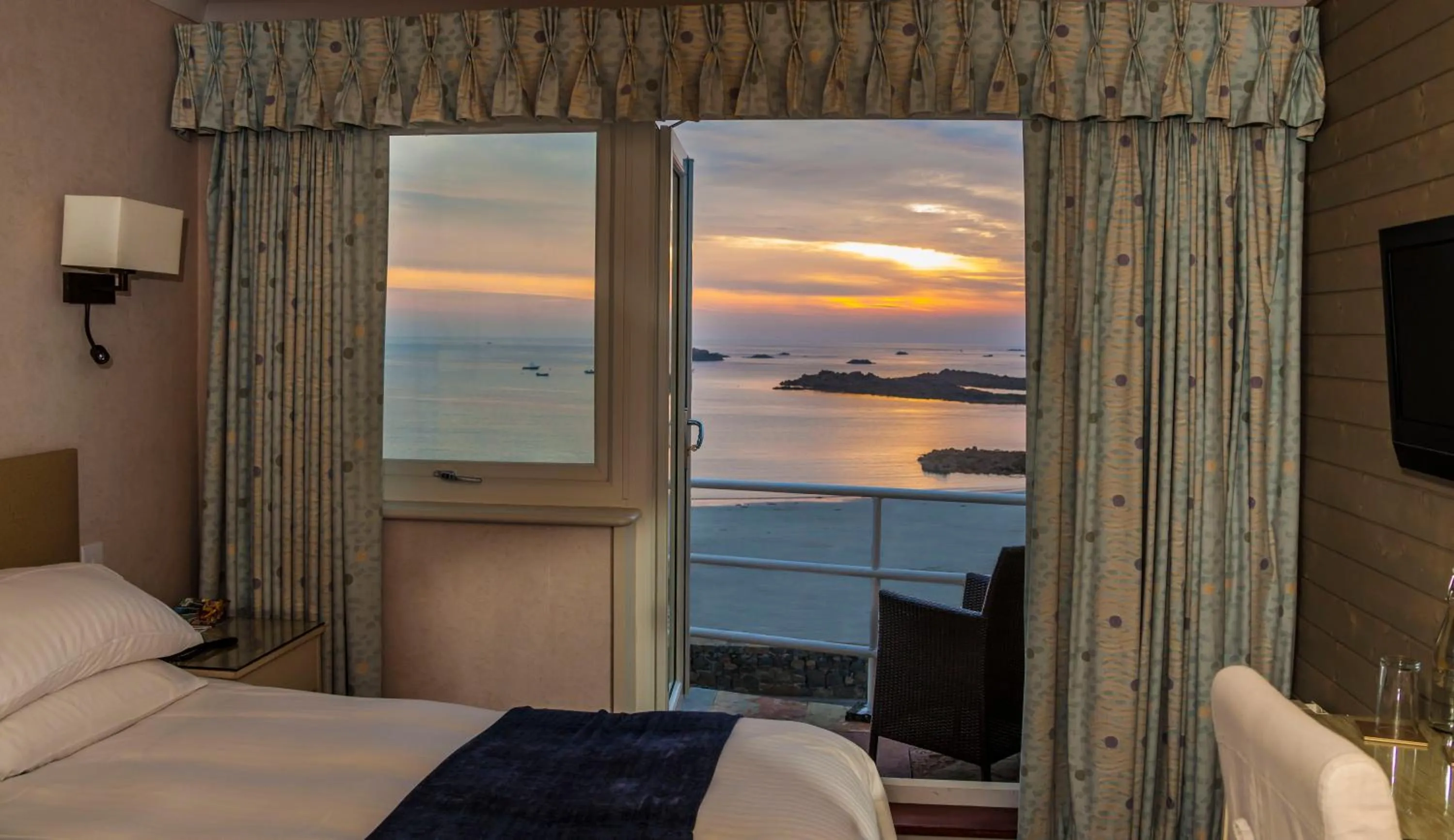 View (from property/room), Bed in Cobo Bay Hotel