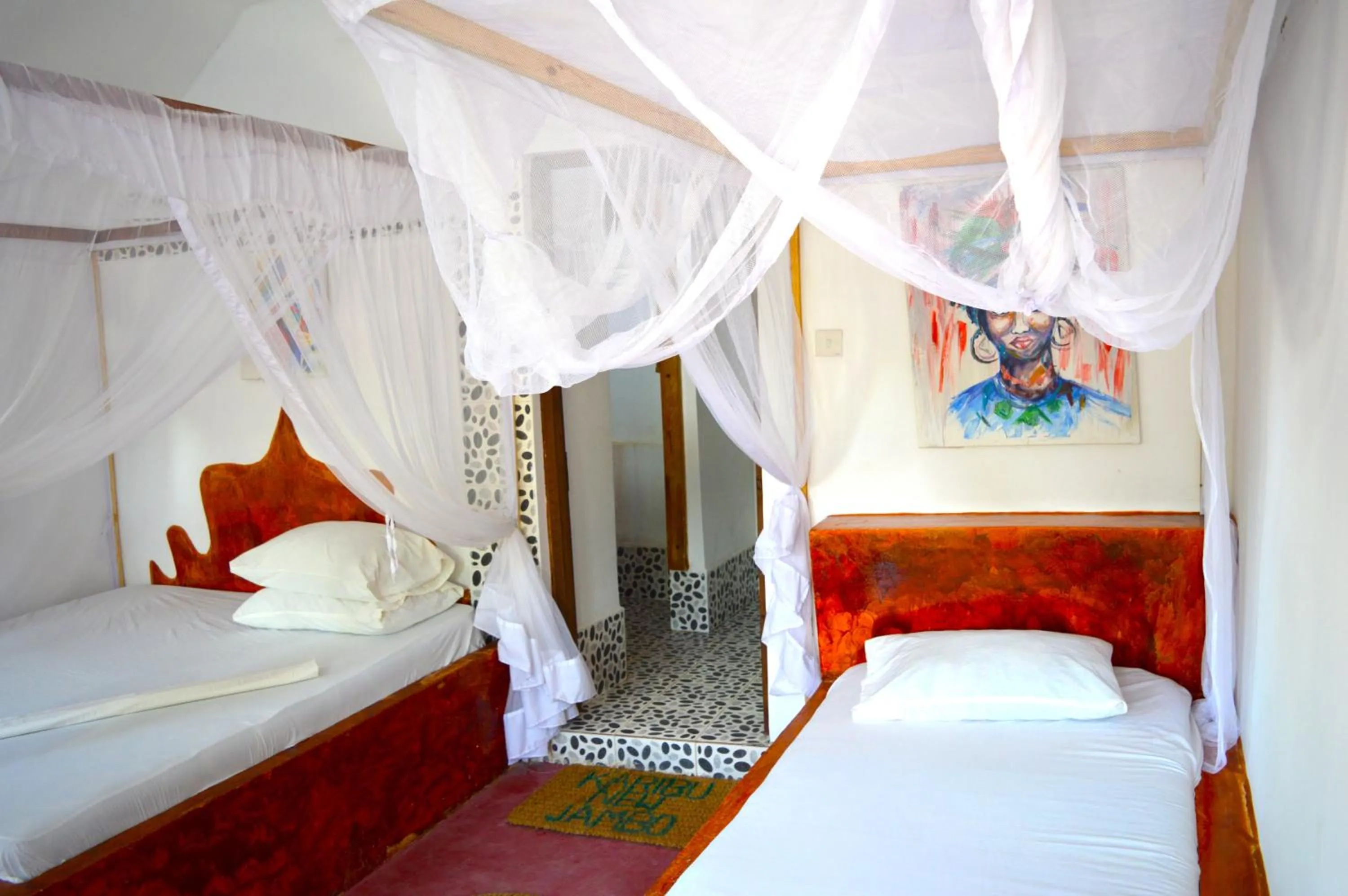 Bed in New Jambo Bungalows
