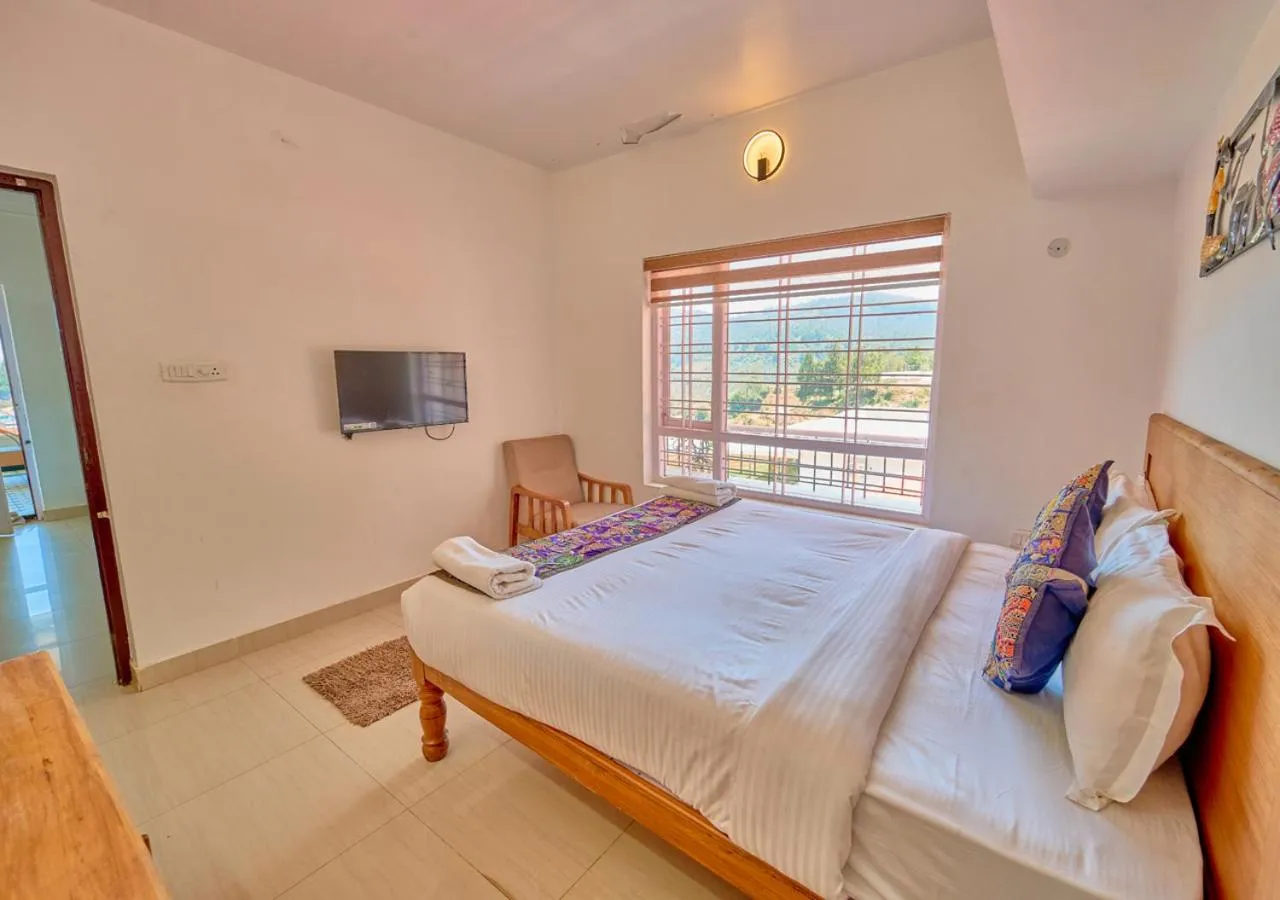 Communal lounge/ TV room, Bed in Silent Retreat Ooty Pool Resort by VOYE HOMES