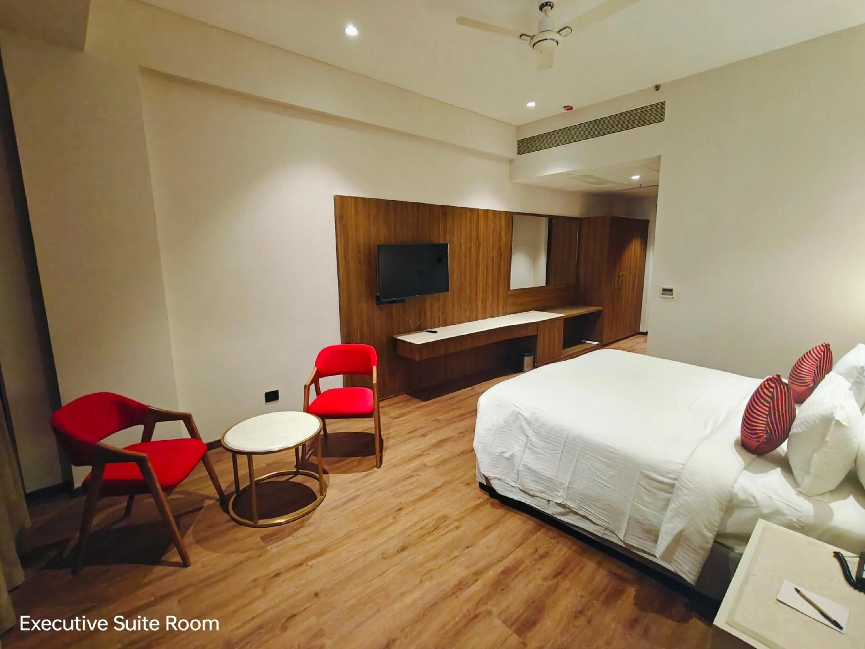 Seating area, Bed in Ramada by Wyndham Ahmedabad Narendra Modi Stadium Motera