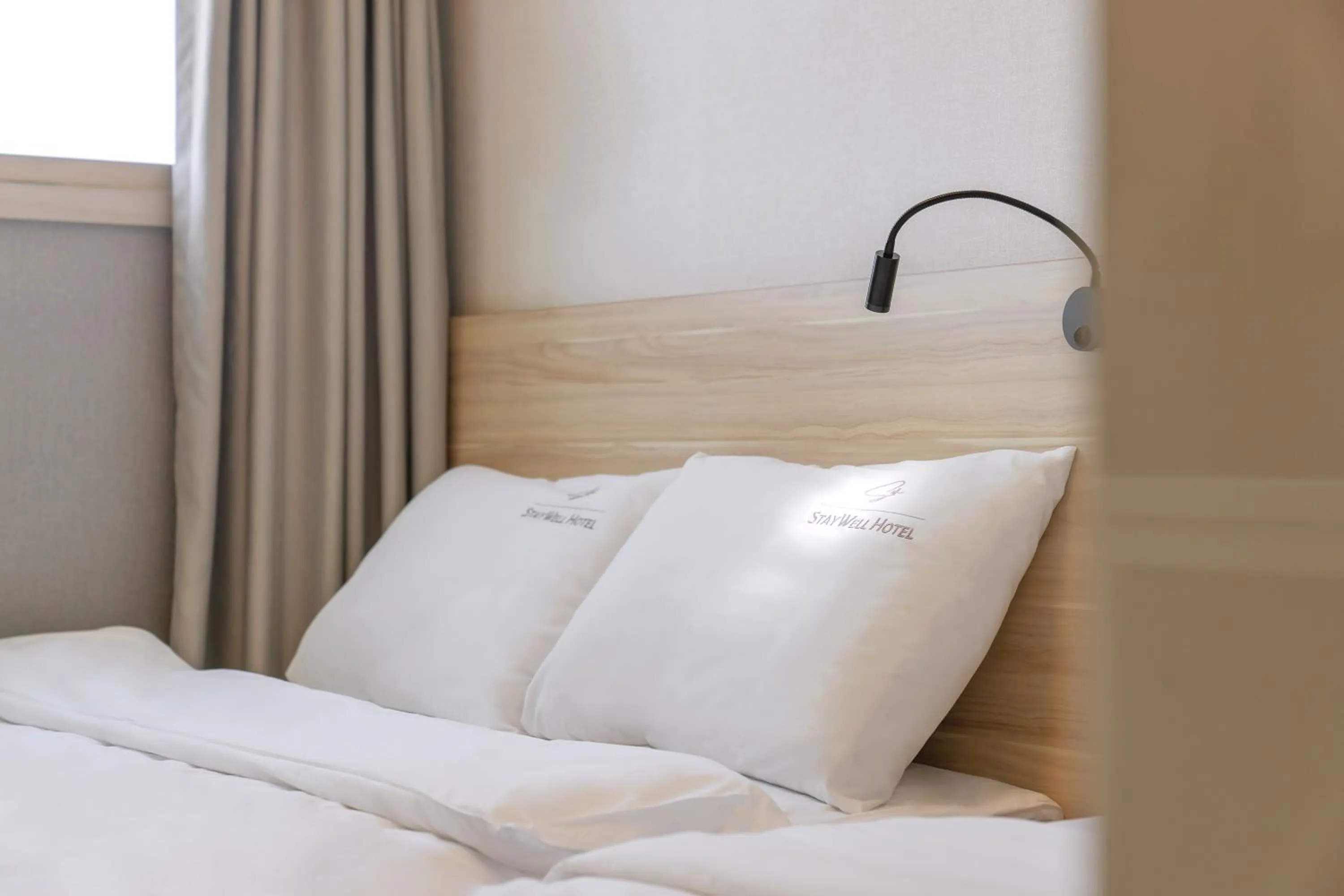 Bed in Staywell Hotel