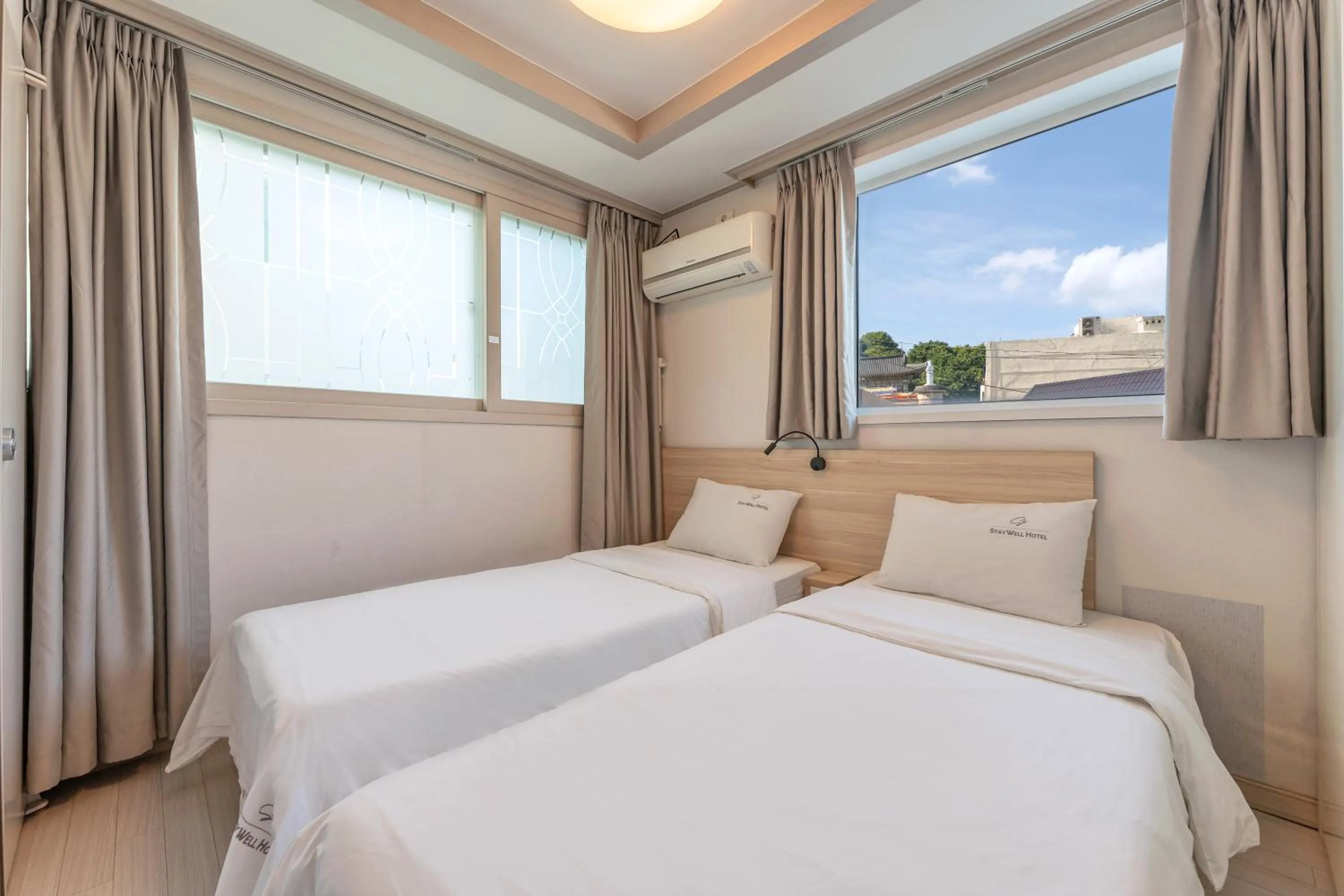 Bed in Staywell Hotel