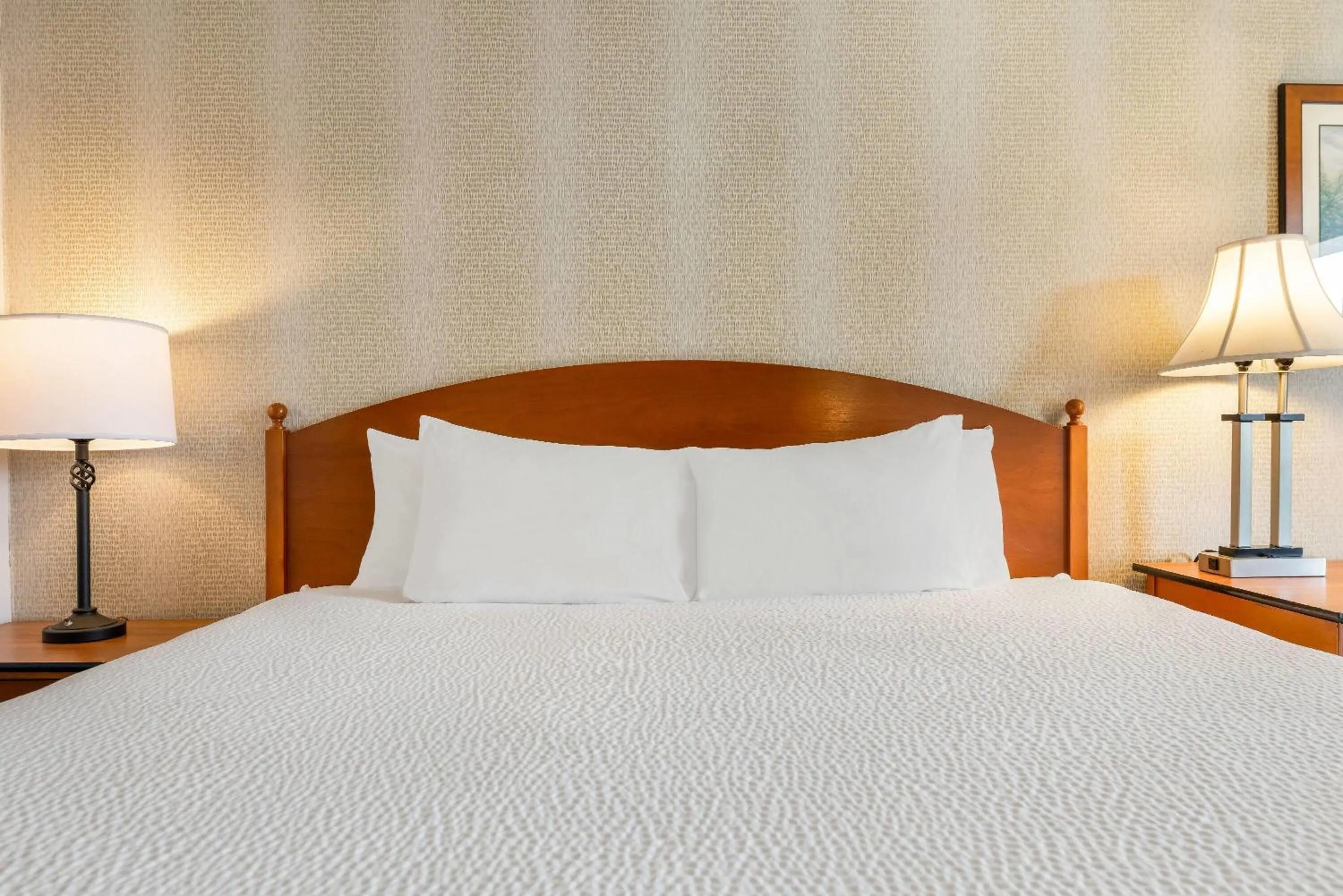 Bed in Ramada by Wyndham State College Hotel & Conference Center