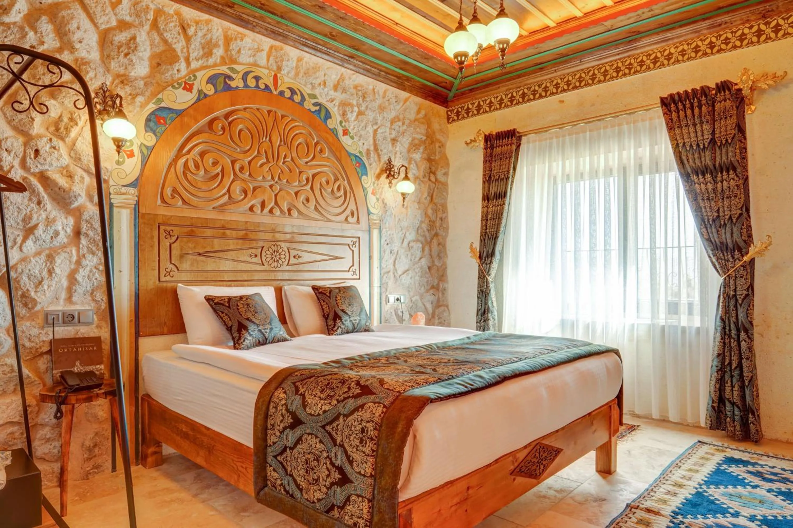 Bed in Kasr-ı Kapadokya Cave Suites