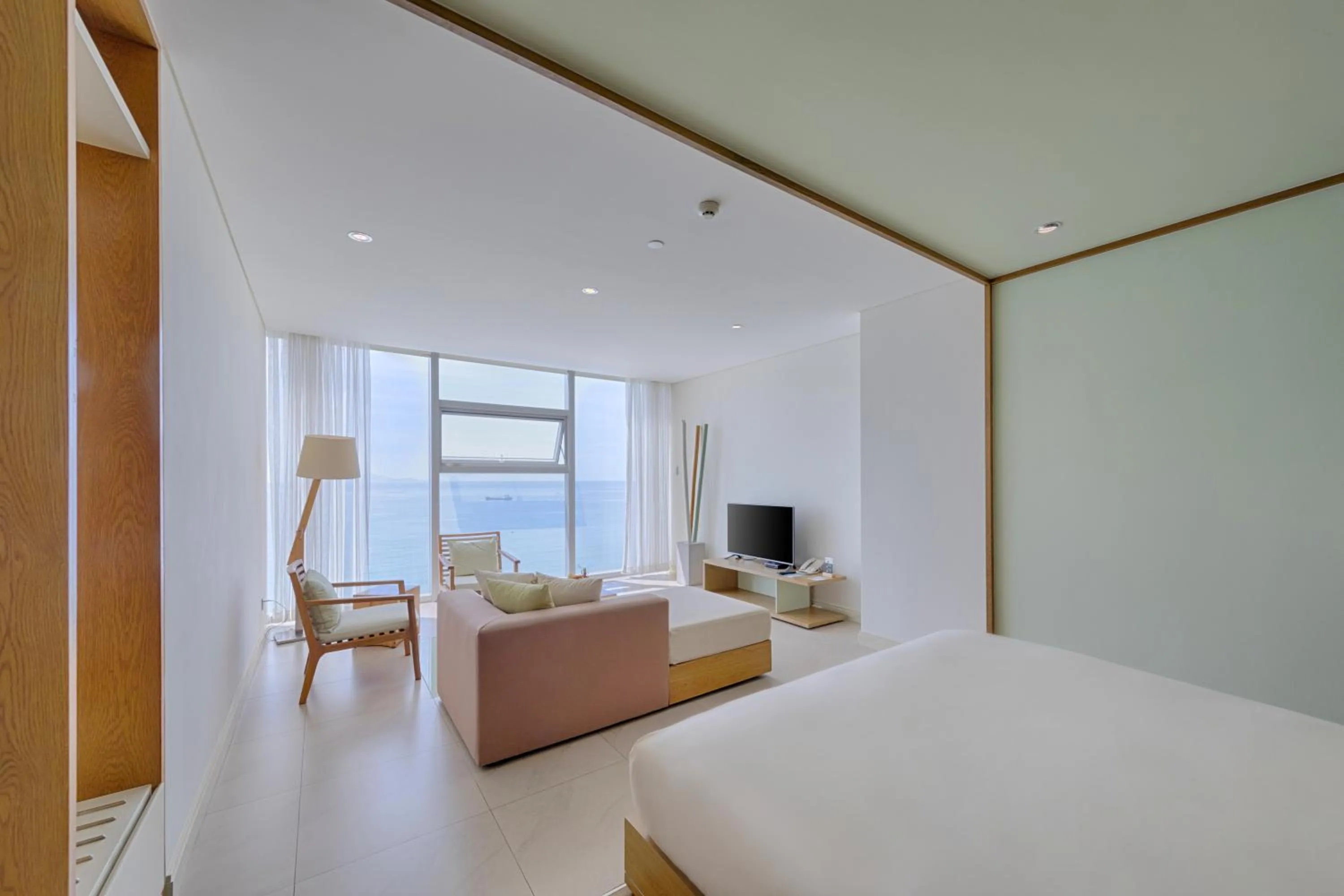 Living room, Bed in Fusion Suites Da Nang