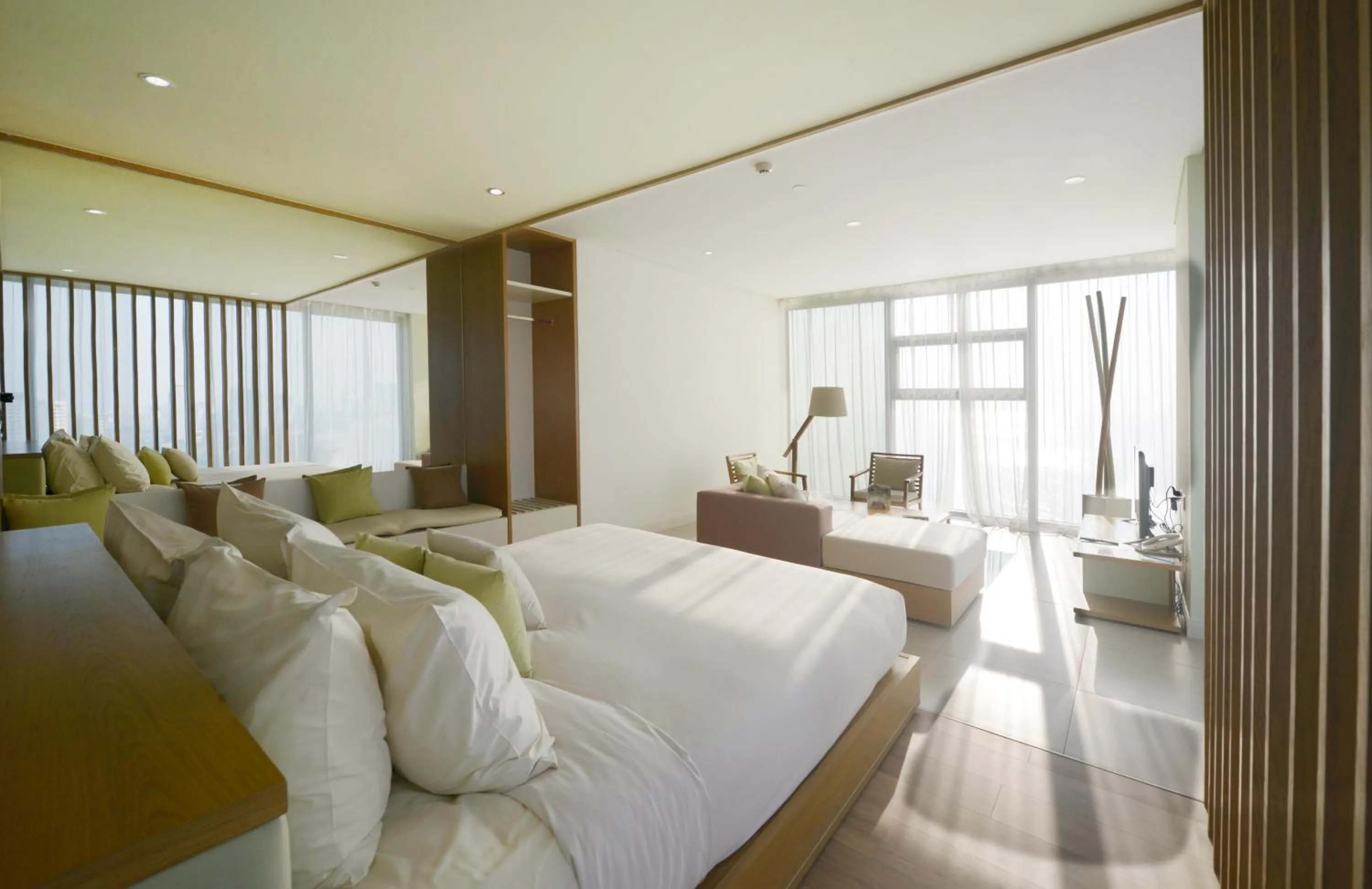 Living room, Bed in Fusion Suites Da Nang