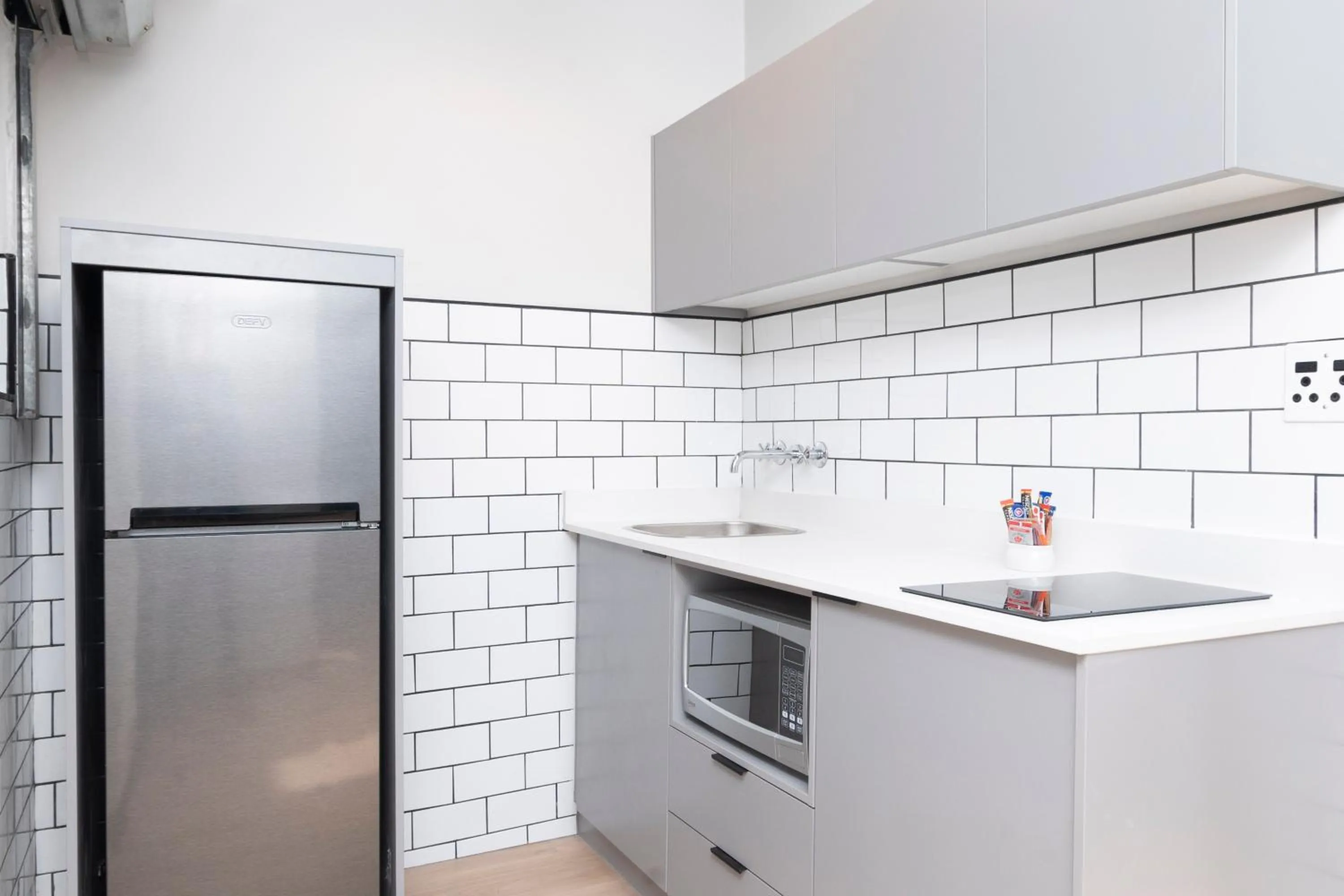 Kitchen or kitchenette in HAVN Aparthotel by Totalstay