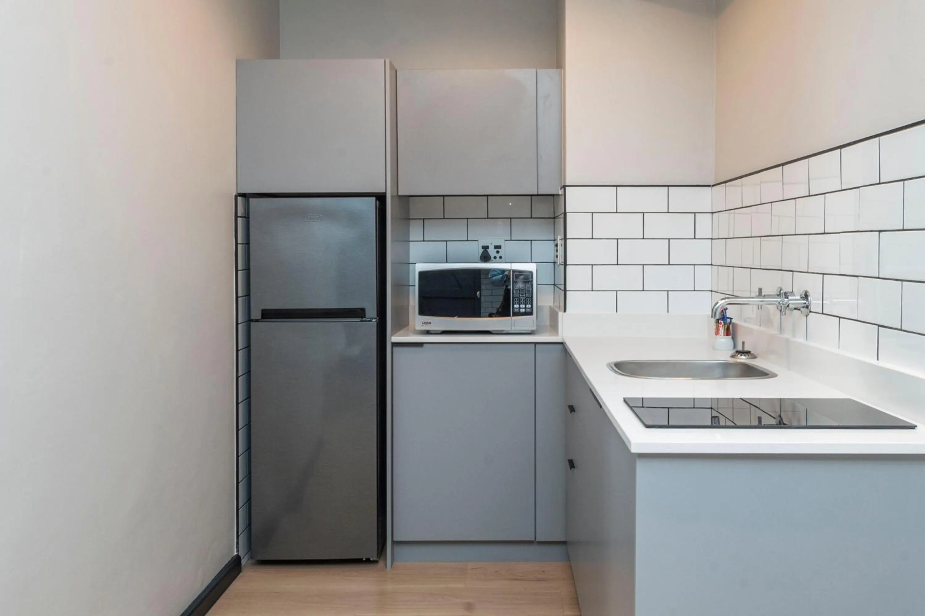 Kitchen or kitchenette in HAVN Aparthotel by Totalstay