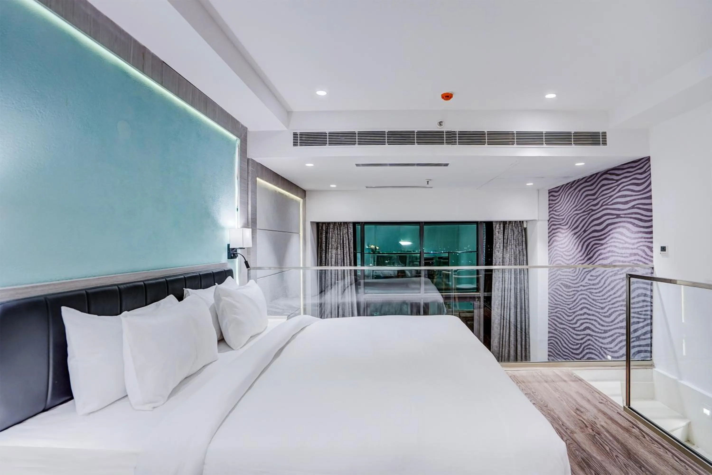 Bed in Sunday Hotel & Residences by CheckIn Gurugram
