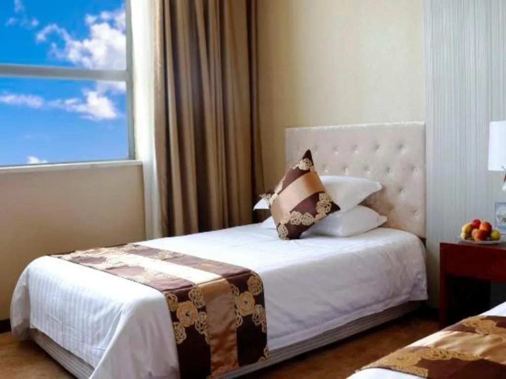 Bed in New Century Hotel Putuo Zhoushan