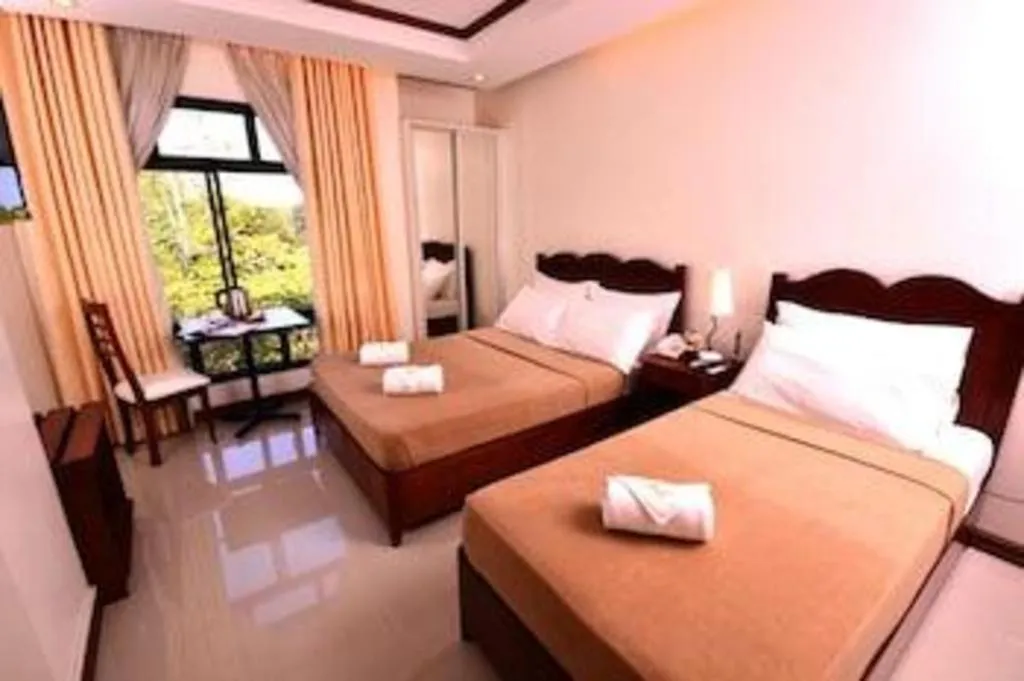 Bed in Ipil Suites Puerto Princesa
