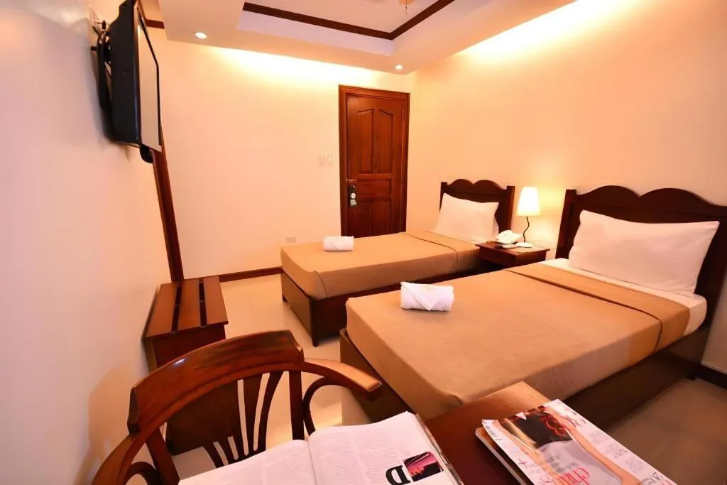 Bed in Ipil Suites Puerto Princesa