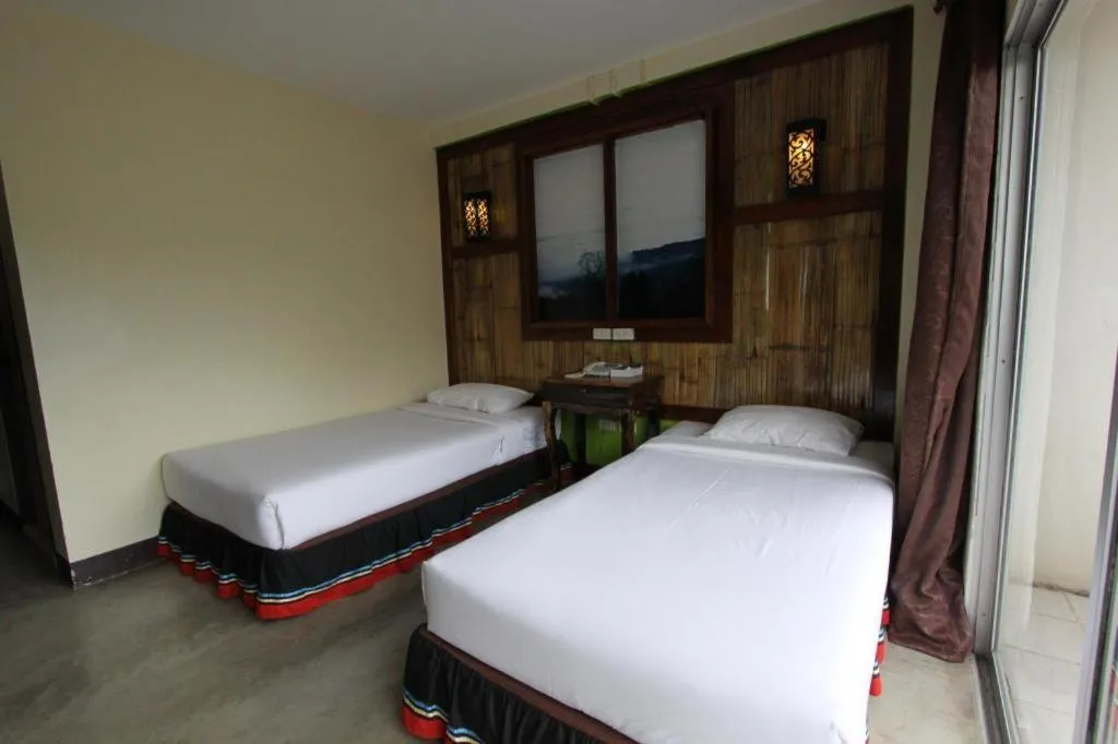 Bed in Phumanee Home Hotel