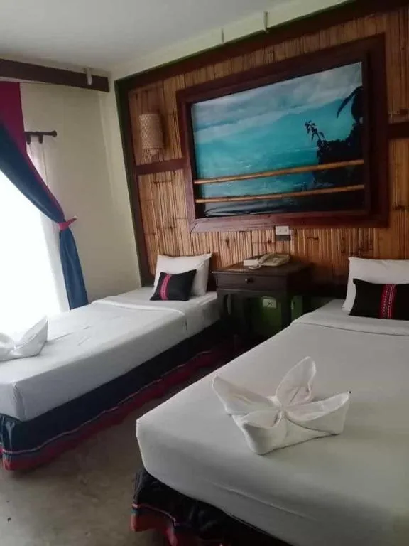 Bed in Phumanee Home Hotel