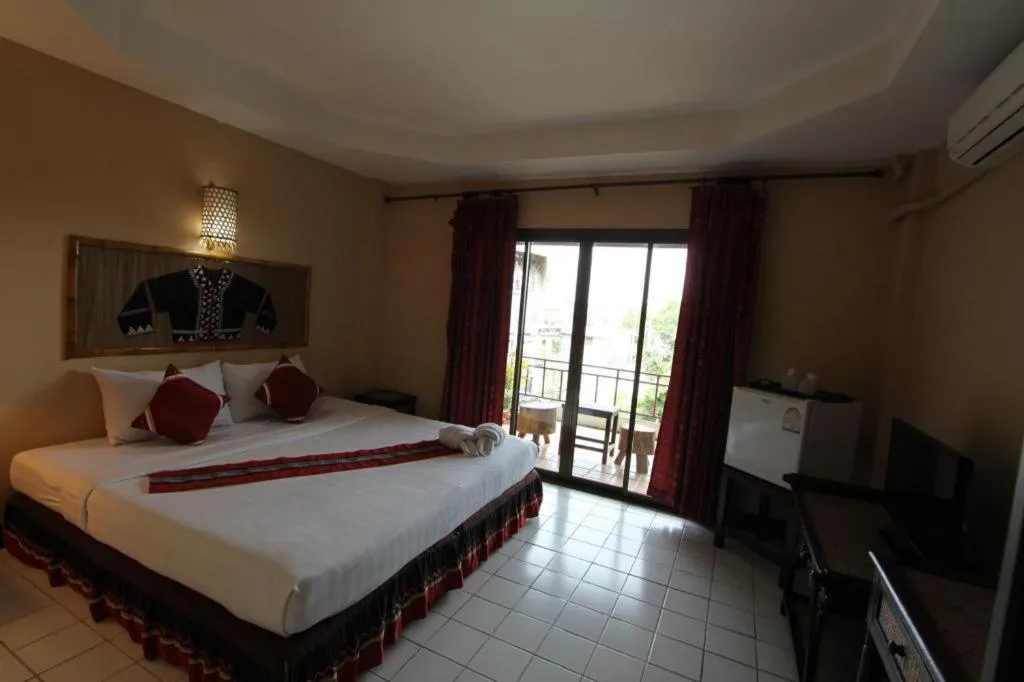 Bed in Phumanee Home Hotel