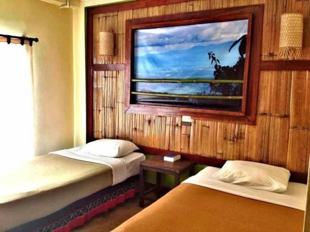 Bed in Phumanee Home Hotel