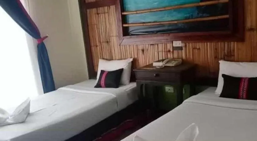 Bed in Phumanee Home Hotel