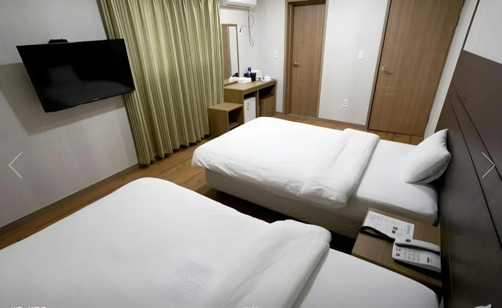 Bed in CJ Tourist Hotel