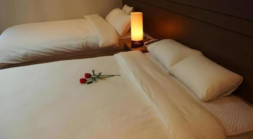 Bed in CJ Tourist Hotel
